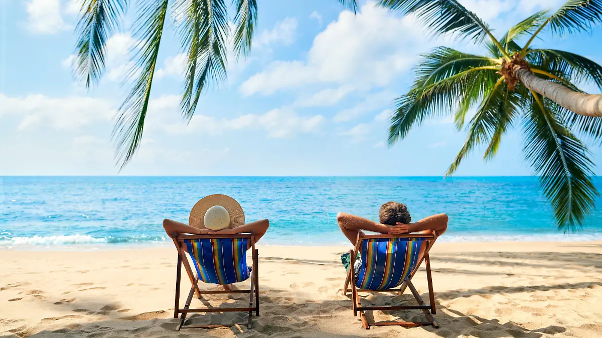 Couple relax on the beach enjoy beautiful sea on the tropical island. Summer beach vacation concept