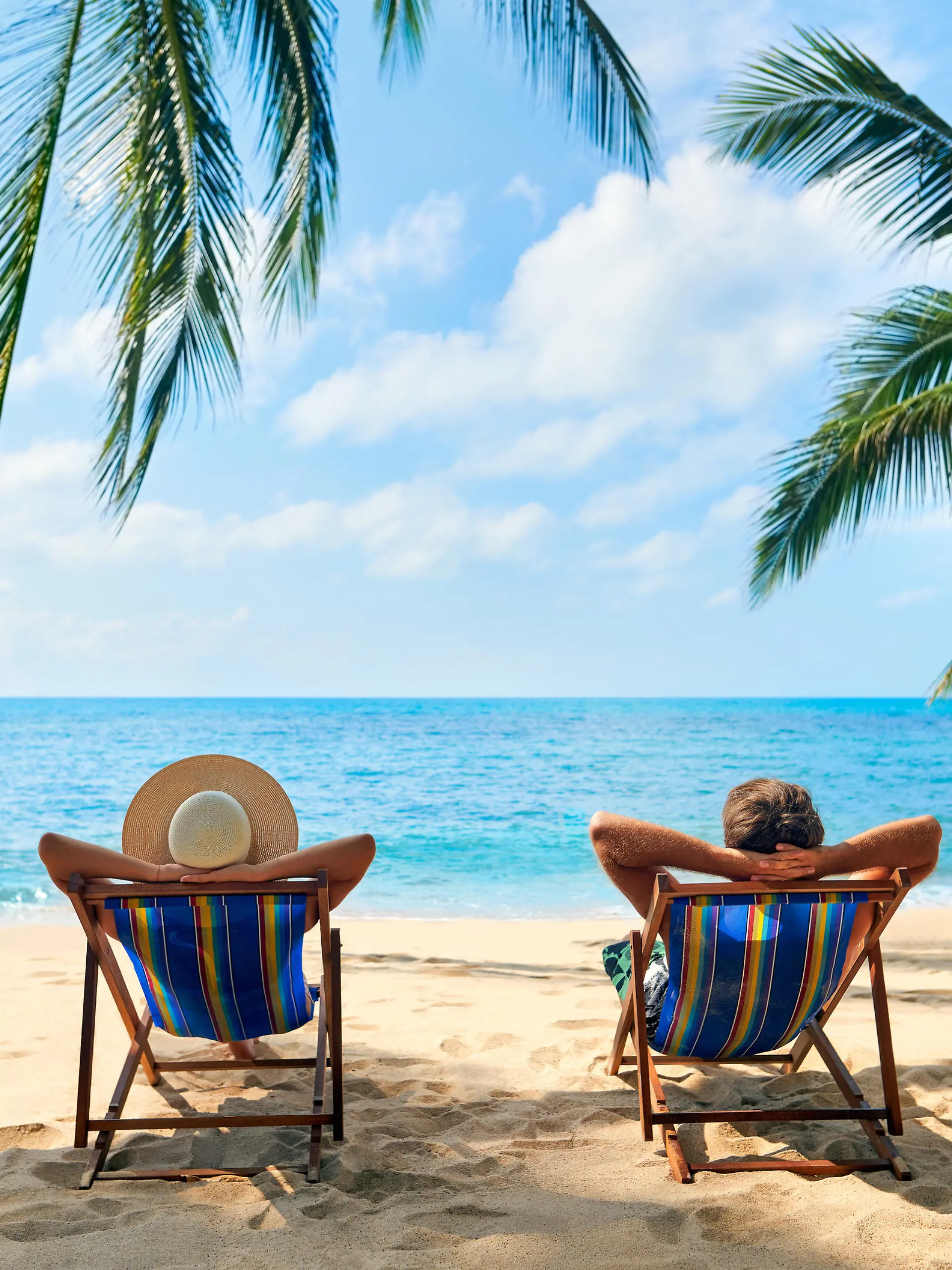 Couple relax on the beach enjoy beautiful sea on the tropical island. Summer beach vacation concept