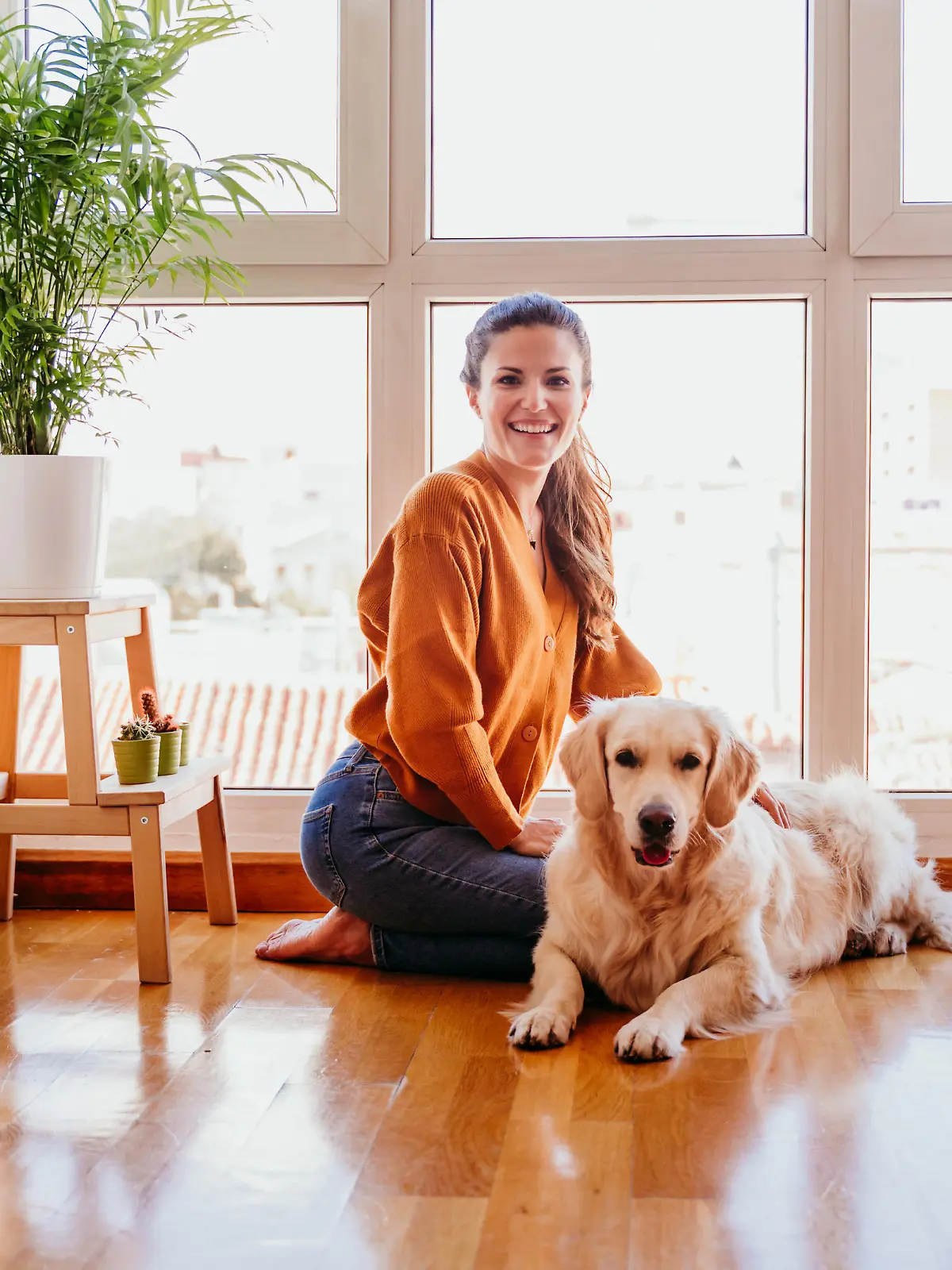 beautiful woman hugging her adorable golden retriever dog at home. love for animals concept. lifestyle indoors