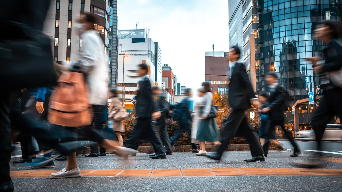 Crowd of business people on their way from work. They are unrecognisable. Long exposure shot.