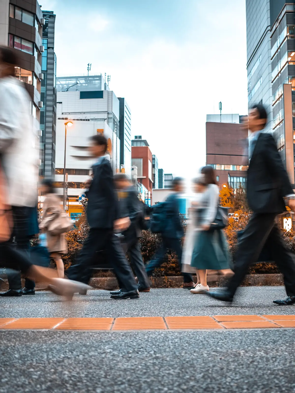 Crowd of business people on their way from work. They are unrecognisable. Long exposure shot.