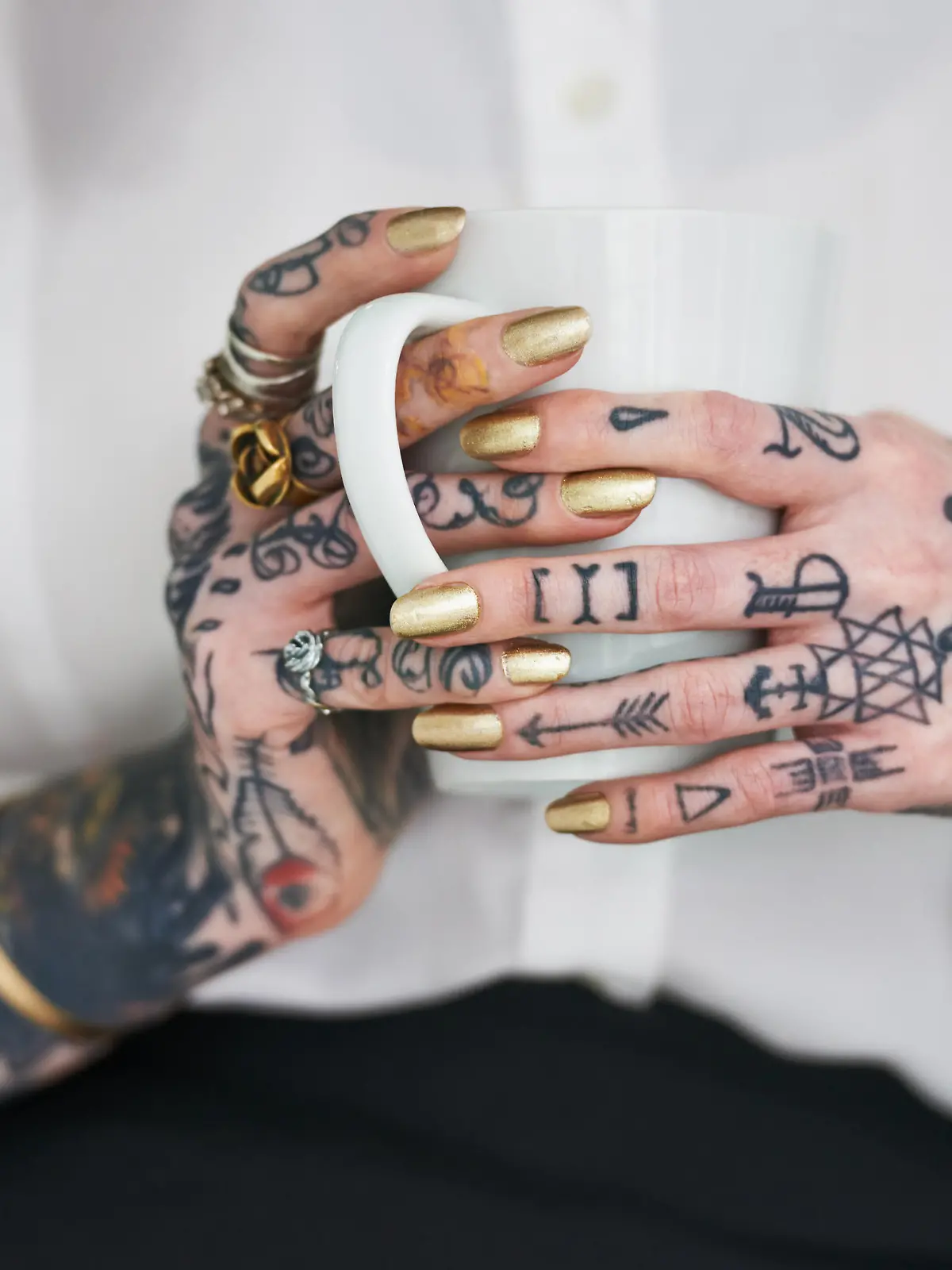Shot of an unrecognizable tattooed businesswoman holding a mug