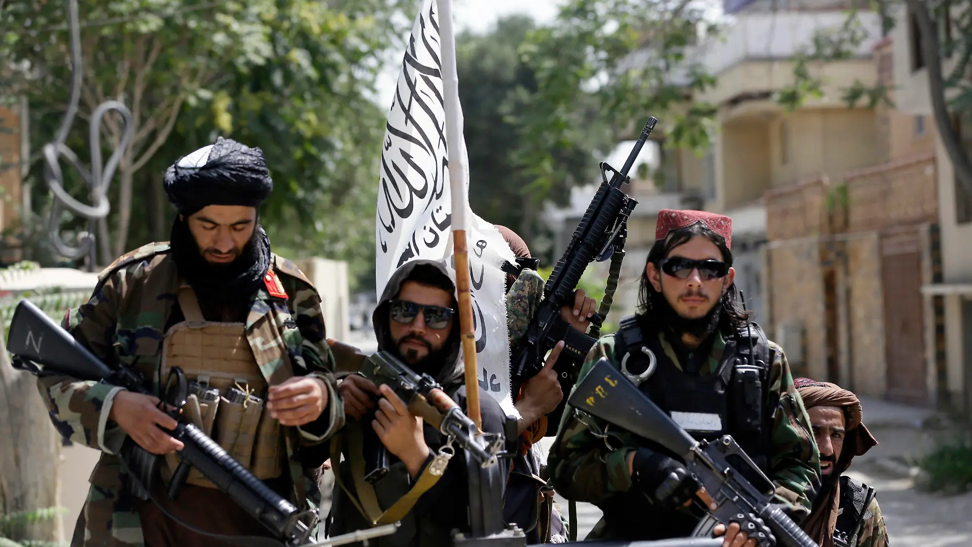 FILE - In this Aug. 19, 2021, file photo, Taliban fighters display their flag on patrol in Kabul, Afghanistan. The Taliban win in Afghanistan gave a boost to militants in neighboring Pakistan. The Pakistani Taliban, known as the TTP, have become emboldened in tribal areas along the border with Afghanistan. (AP Photo/Rahmat Gul, File)