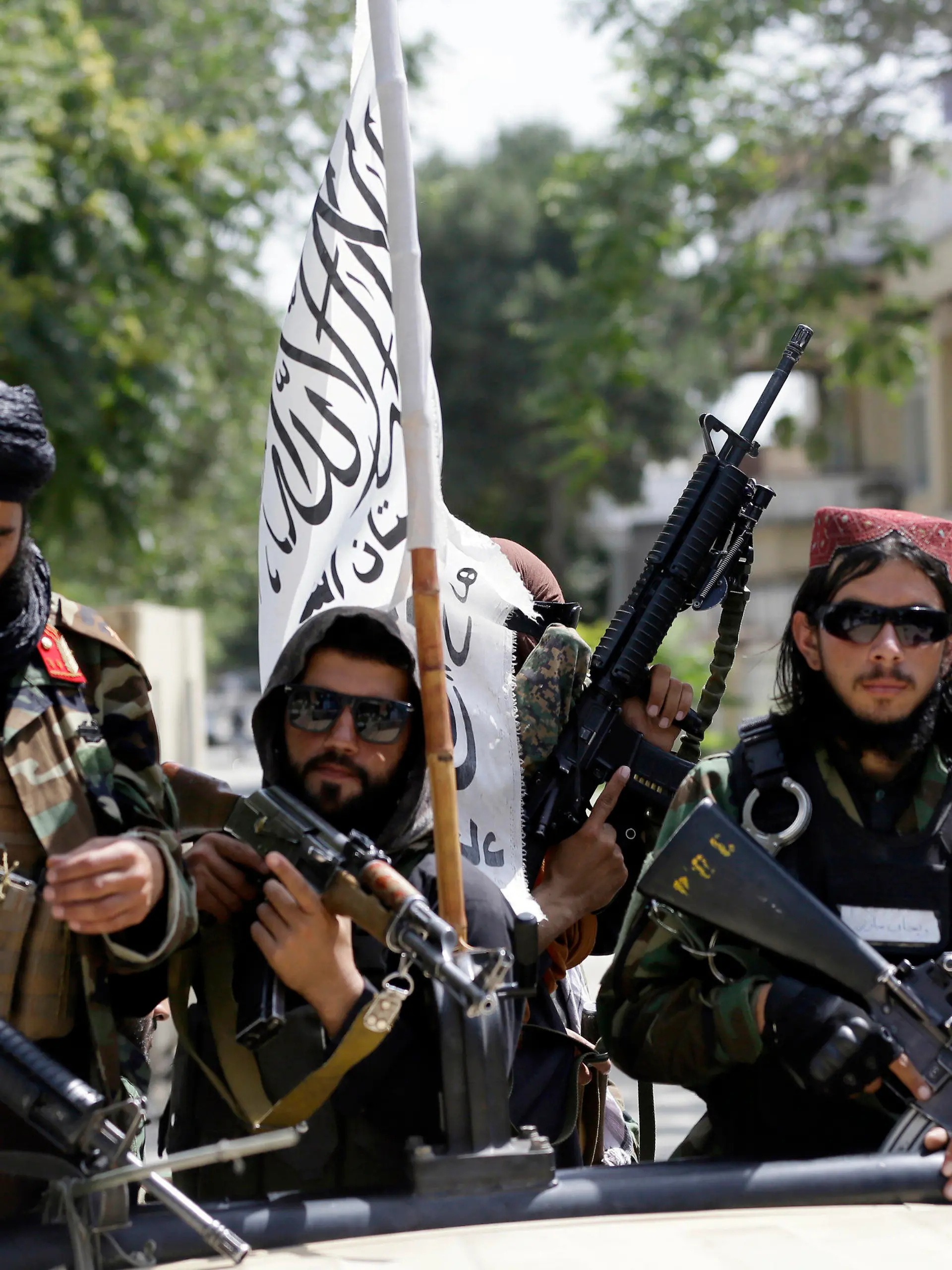 FILE - In this Aug. 19, 2021, file photo, Taliban fighters display their flag on patrol in Kabul, Afghanistan. The Taliban win in Afghanistan gave a boost to militants in neighboring Pakistan. The Pakistani Taliban, known as the TTP, have become emboldened in tribal areas along the border with Afghanistan. (AP Photo/Rahmat Gul, File)