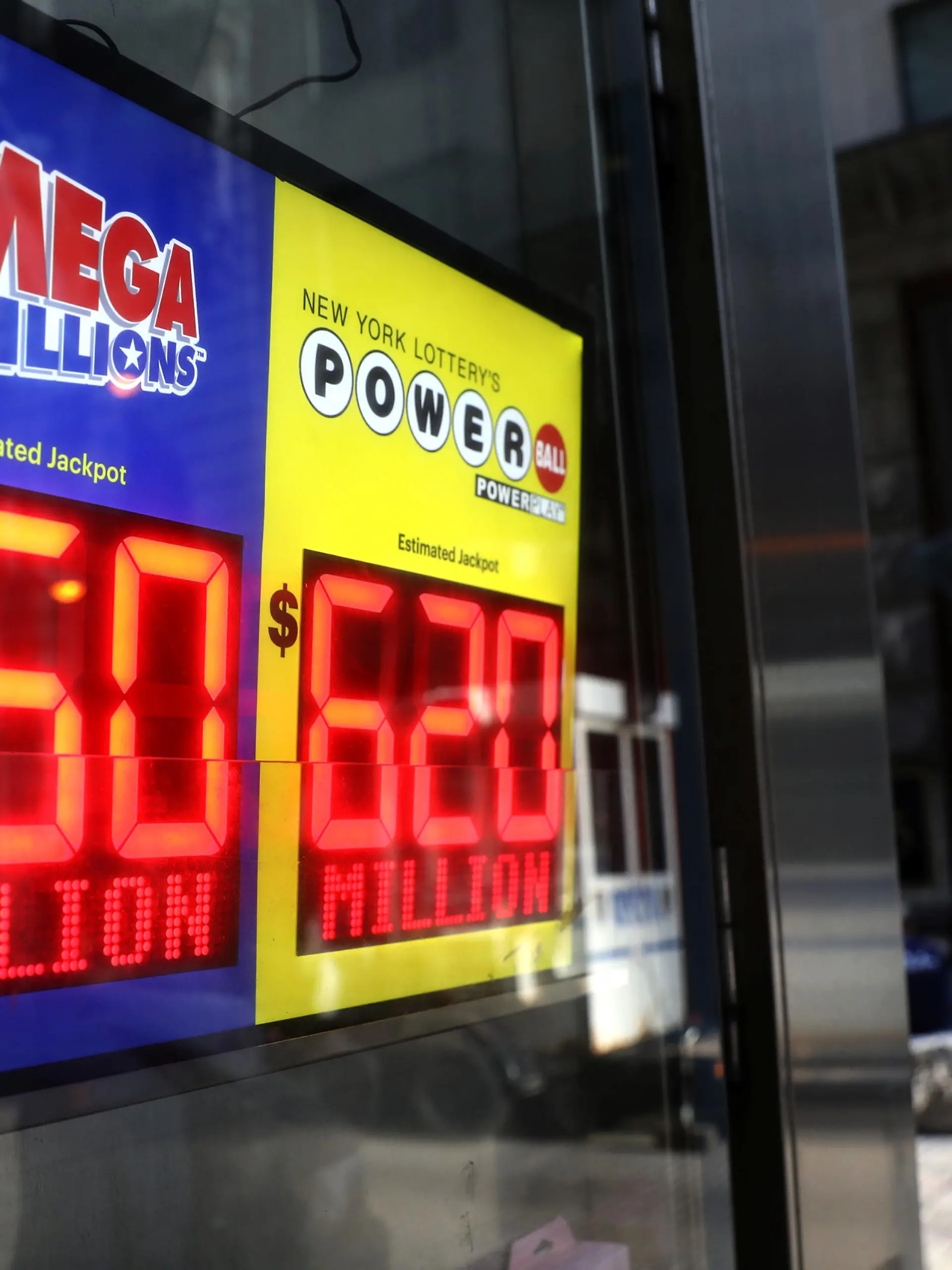 Signs display the jackpots for Tuesday's Mega Millions and Wednesday's Powerball lottery drawings in New York City, New York, U.S., October 23, 2018. REUTERS/Mike Segar