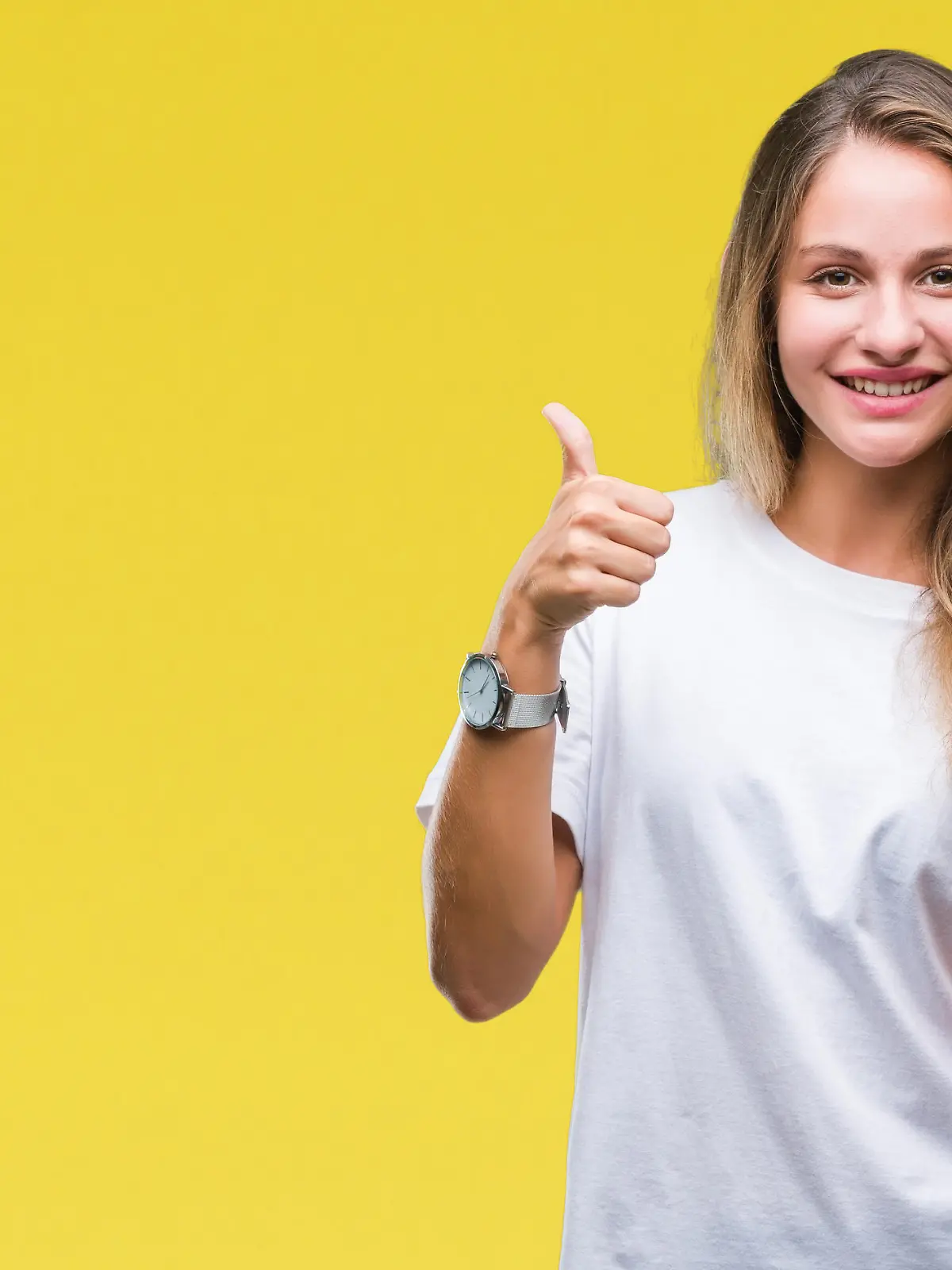 Young beautiful blonde woman using smartphone over isolated background happy with big smile doing ok sign, thumb up with fingers, excellent sign