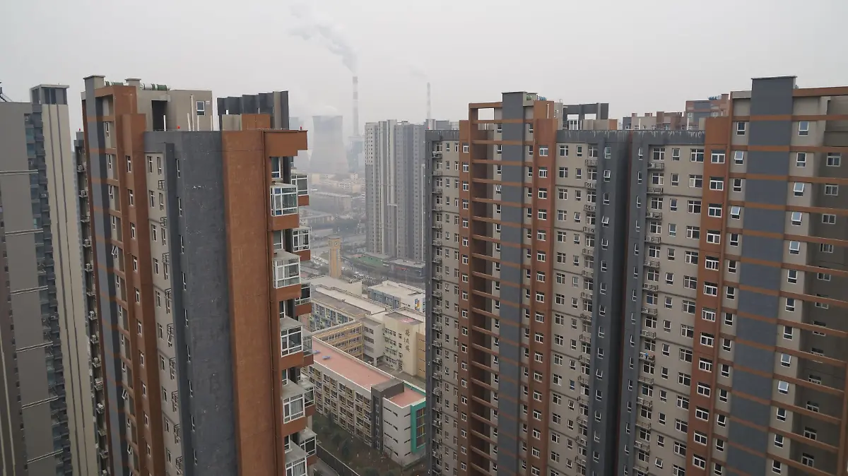 XI'AN, CHINA - DECEMBER 23, 2021 - A view of a coal-fired power plant and buildings in Xi 'an, Shaanxi Province, China, on December 23, 2021. Xi 'an has implemented city-wide closed management of units and communities.