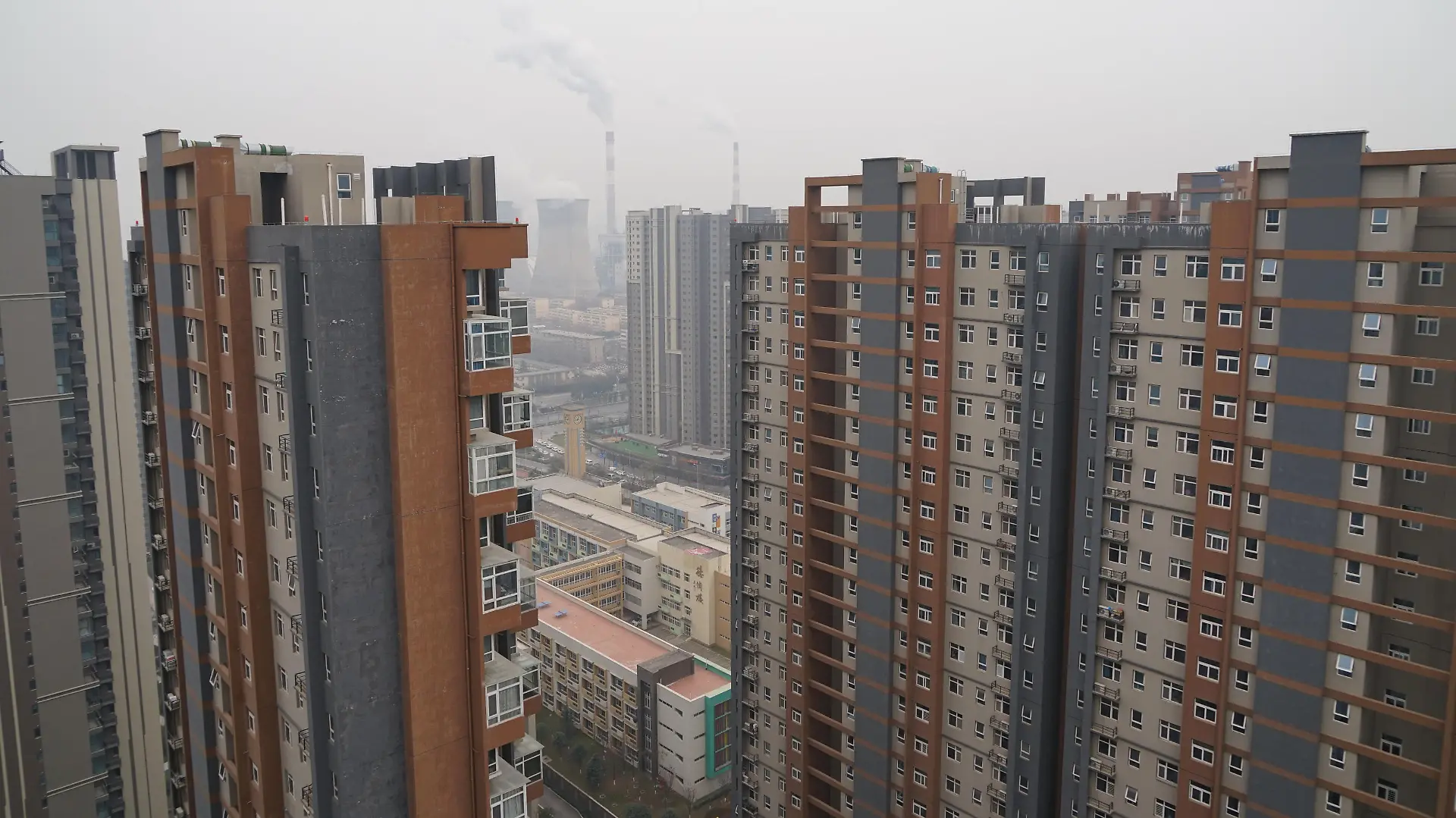 XI'AN, CHINA - DECEMBER 23, 2021 - A view of a coal-fired power plant and buildings in Xi 'an, Shaanxi Province, China, on December 23, 2021. Xi 'an has implemented city-wide closed management of units and communities.