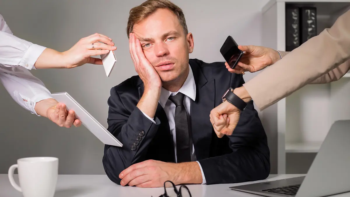 Tired man being overloaded at work