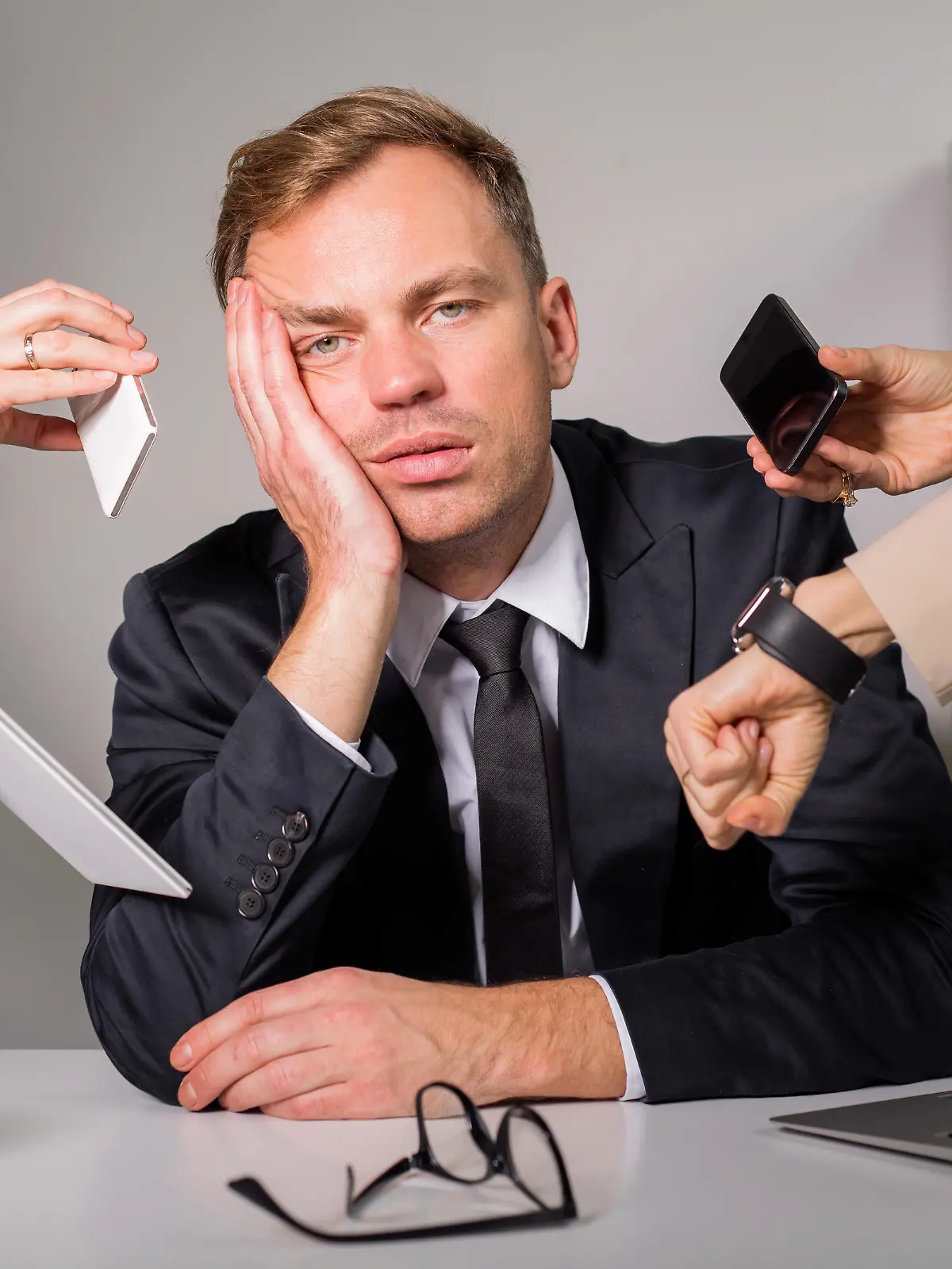 Tired man being overloaded at work