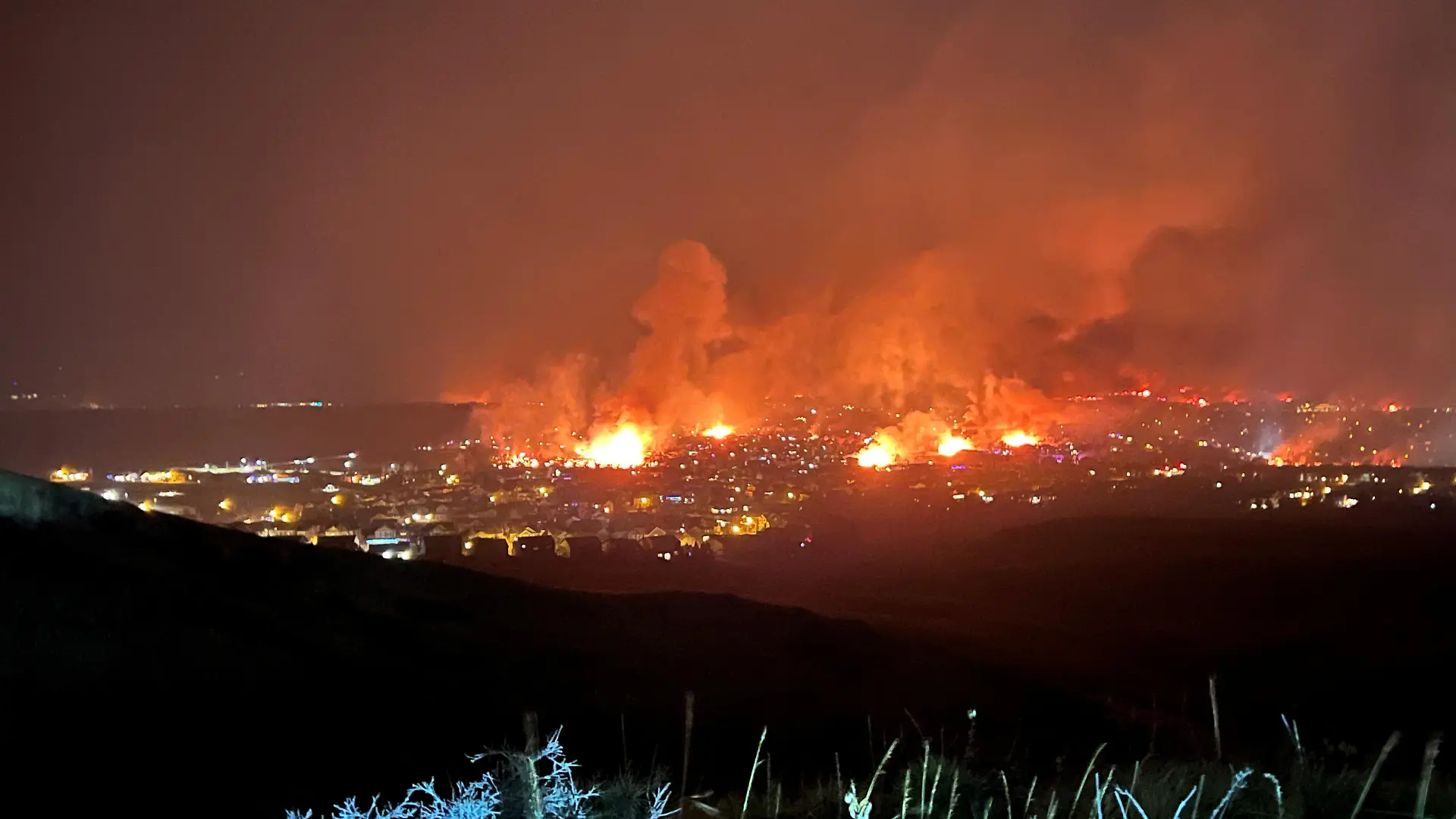 Buildings burn as a wind-driven grass fire destroys hundreds of homes, displaces thousands, as seen from Denver, Colorado, U.S. December 30, 2021. Gregg Corella/Handout via REUTERS THIS IMAGE HAS BEEN SUPPLIED BY A THIRD PARTY. MANDATORY CREDIT. NO RESALES. NO ARCHIVES.