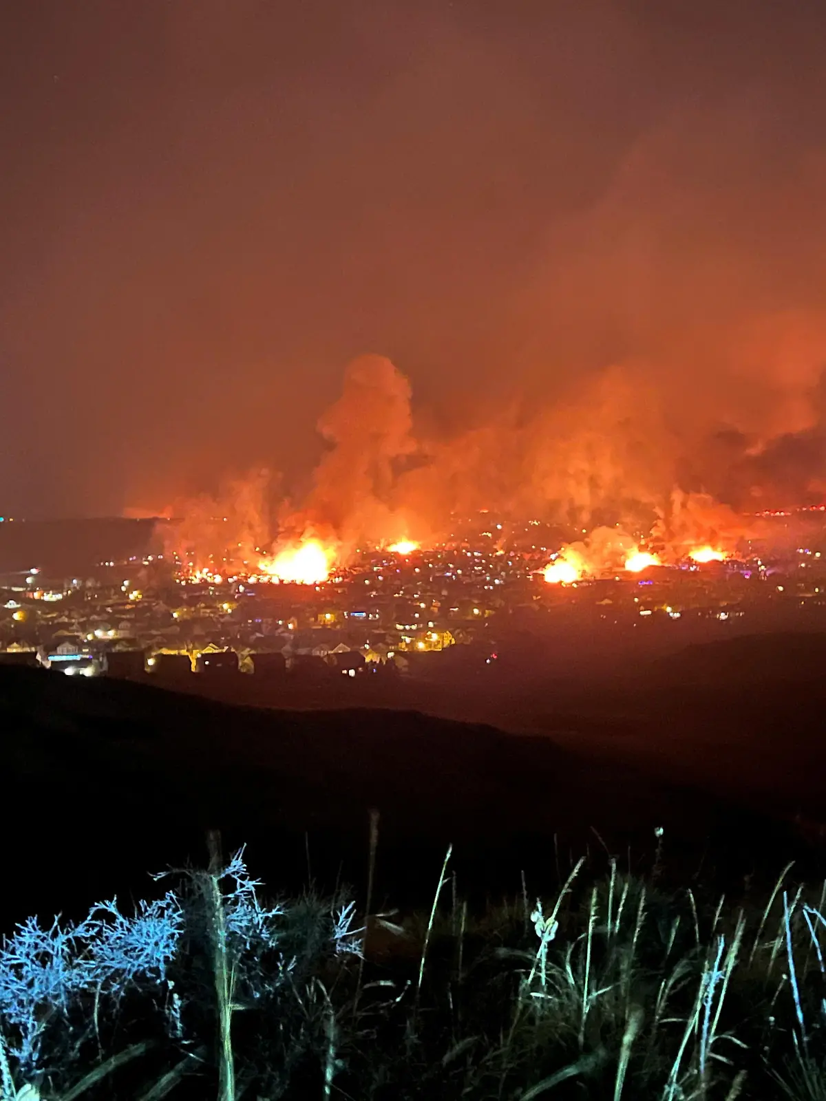 Buildings burn as a wind-driven grass fire destroys hundreds of homes, displaces thousands, as seen from Denver, Colorado, U.S. December 30, 2021. Gregg Corella/Handout via REUTERS THIS IMAGE HAS BEEN SUPPLIED BY A THIRD PARTY. MANDATORY CREDIT. NO RESALES. NO ARCHIVES.