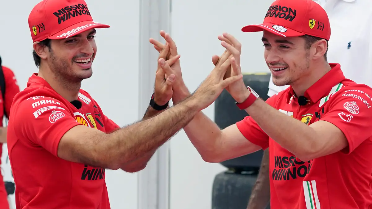 Ferrari drivers Carlos Sainz, left, of Spain, and Charles Leclerc, of Monaco, celebrate as they shoot free throws at the Formula One U.S. Grand Prix auto race at the Circuit of the Americas, Thursday, Oct. 21, 2021, in Austin, Texas. F1 teams took part in a free throw challenge to help the NBA celebrate its 75th anniversary. (AP Photo/Eric Gay)