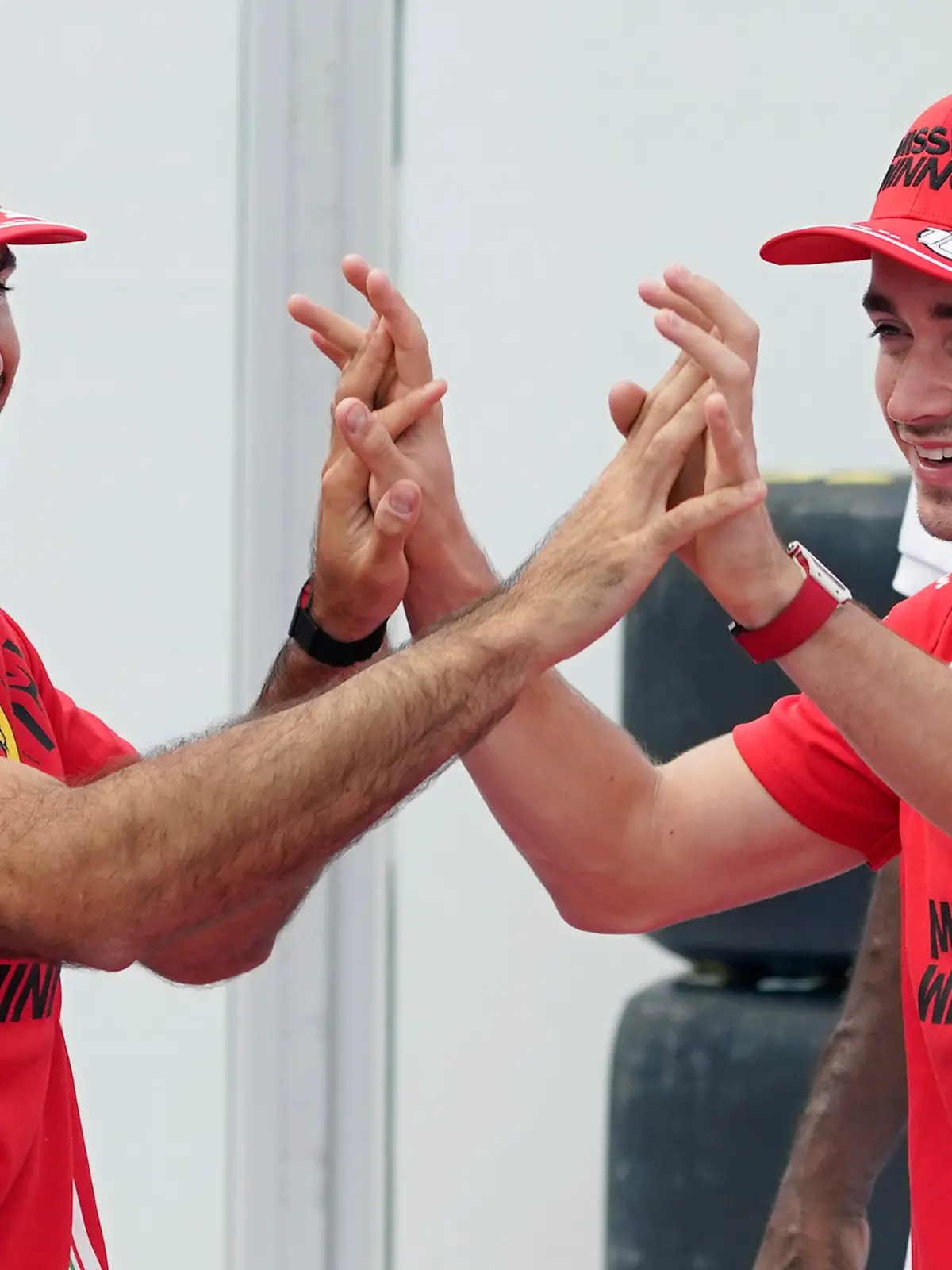 Ferrari drivers Carlos Sainz, left, of Spain, and Charles Leclerc, of Monaco, celebrate as they shoot free throws at the Formula One U.S. Grand Prix auto race at the Circuit of the Americas, Thursday, Oct. 21, 2021, in Austin, Texas. F1 teams took part in a free throw challenge to help the NBA celebrate its 75th anniversary. (AP Photo/Eric Gay)