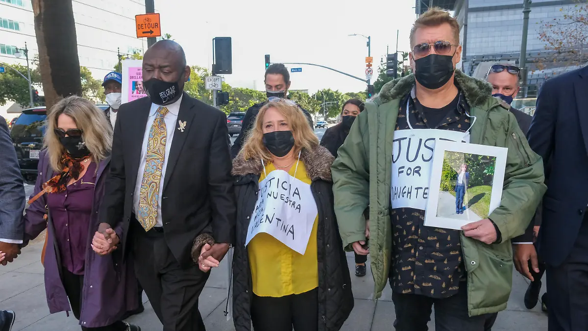 Juan Pablo Orellana Larenas, right, Soledad Peralta, second from right, the parents of Valentina Orellana-Peralta, and attorney Ben Crump, second left, arrive for a news conference outside the Los Angeles Police Department headquarters in Los Angeles, Tuesday, Dec. 28, 2021. The parents of Valentina Orellana-Peralta, the 14-year-old girl killed by a stray bullet fired by an LAPD officer at a North Hollywood clothing store last week, and their attorneys held a news conference to discuss the family's demand for transparency from the Los Angeles Police Department. (AP Photo/Ringo H.W. Chiu)