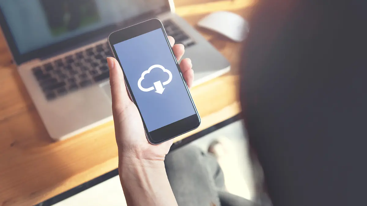Closeup hand of woman with Cloud download on mobile smartphone.