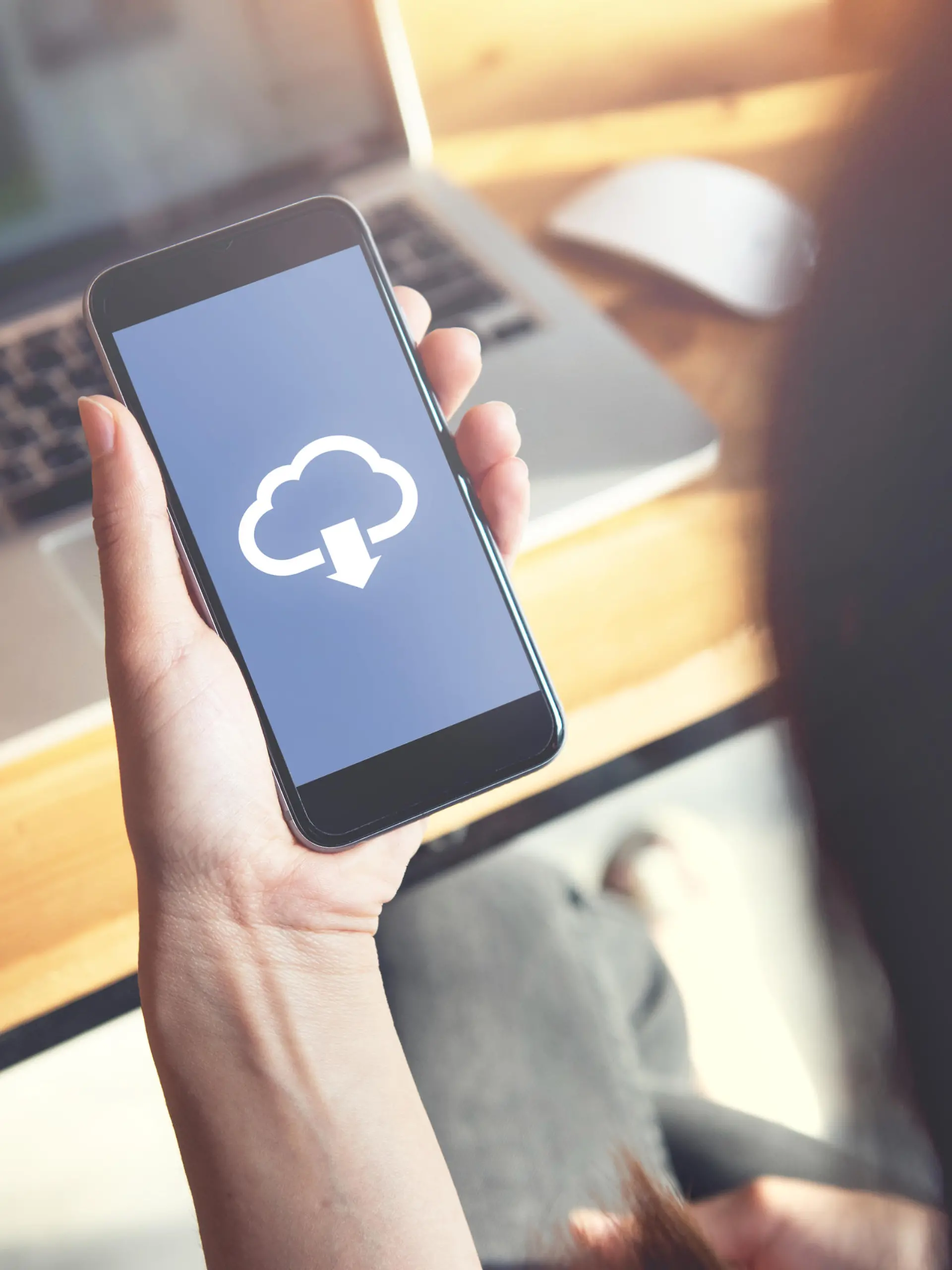 Closeup hand of woman with Cloud download on mobile smartphone.