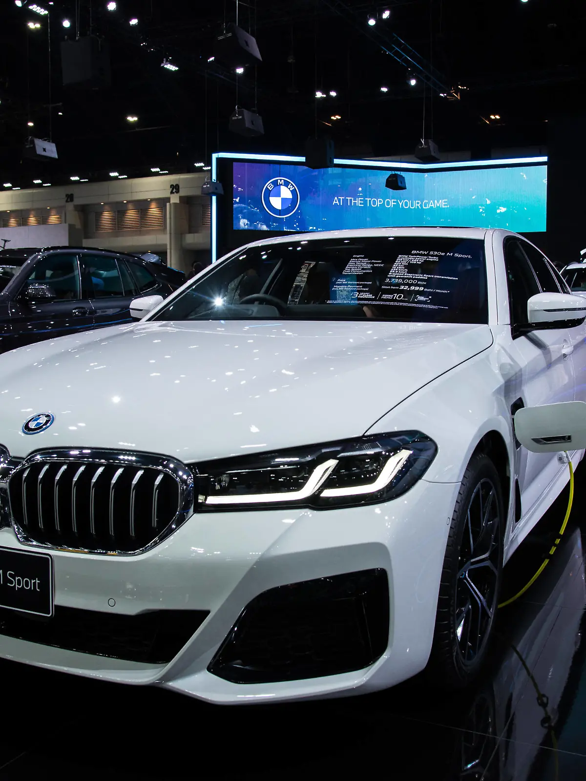  December 3, 2021, Nonthaburi, Thailand: A model poses next to a BMW 530e M Sport car displayed at the Motor Expo..The 38th Thailand International Motor Expo 2021 held from December 1,2021 to December 12,2021 showcasing 32 car brands and 12 motorcycle brands as well as electric vehicles held to boost the overall sales and pull the auto industry back to business after the economic slowdown caused by the prolonged COVID-19 pandemic. Nonthaburi Thailand - ZUMAs197 20211203_zaa_s197_028 Copyright: xPeeraponxBoonyakiatx