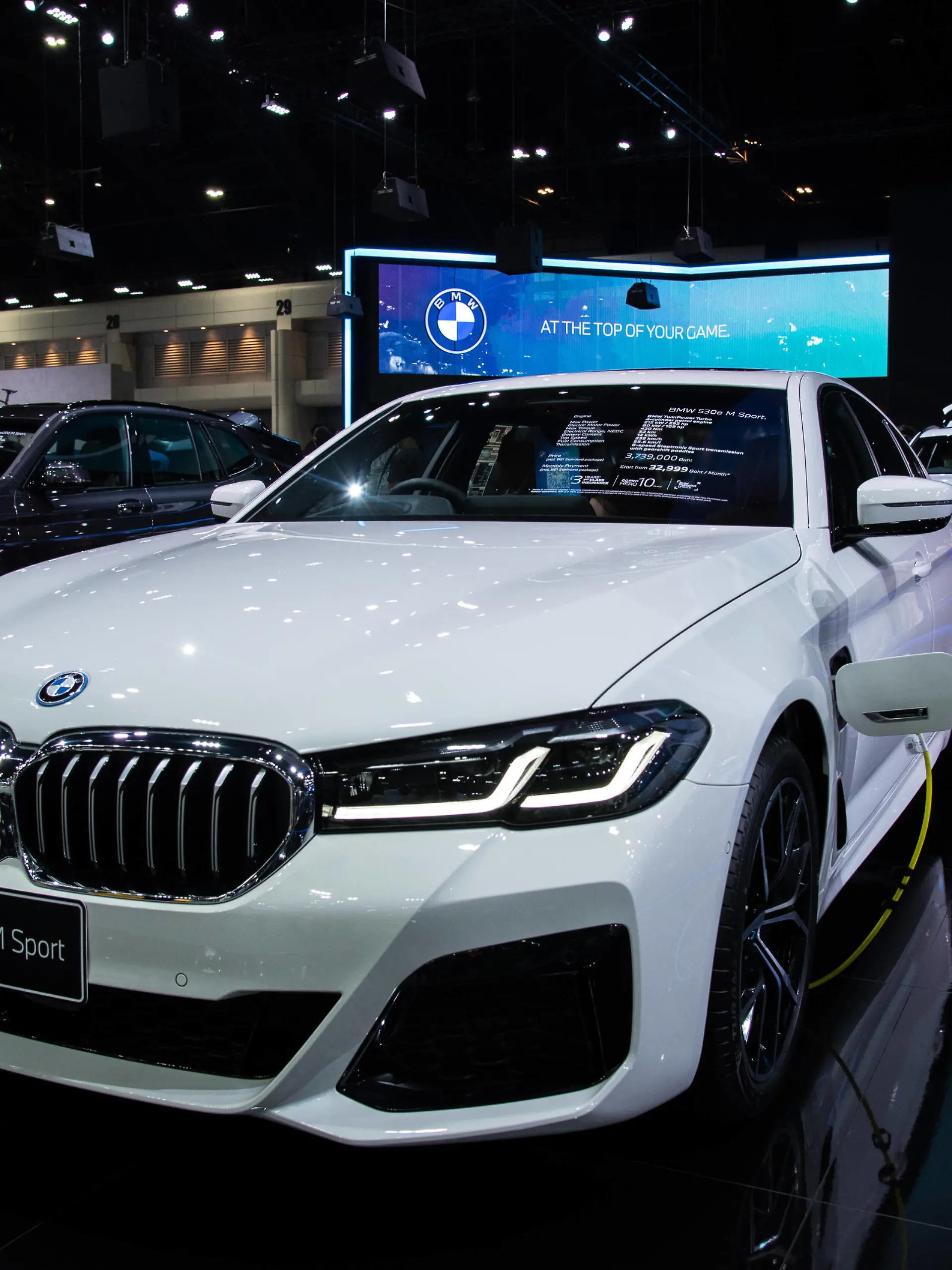  December 3, 2021, Nonthaburi, Thailand: A model poses next to a BMW 530e M Sport car displayed at the Motor Expo..The 38th Thailand International Motor Expo 2021 held from December 1,2021 to December 12,2021 showcasing 32 car brands and 12 motorcycle brands as well as electric vehicles held to boost the overall sales and pull the auto industry back to business after the economic slowdown caused by the prolonged COVID-19 pandemic. Nonthaburi Thailand - ZUMAs197 20211203_zaa_s197_028 Copyright: xPeeraponxBoonyakiatx