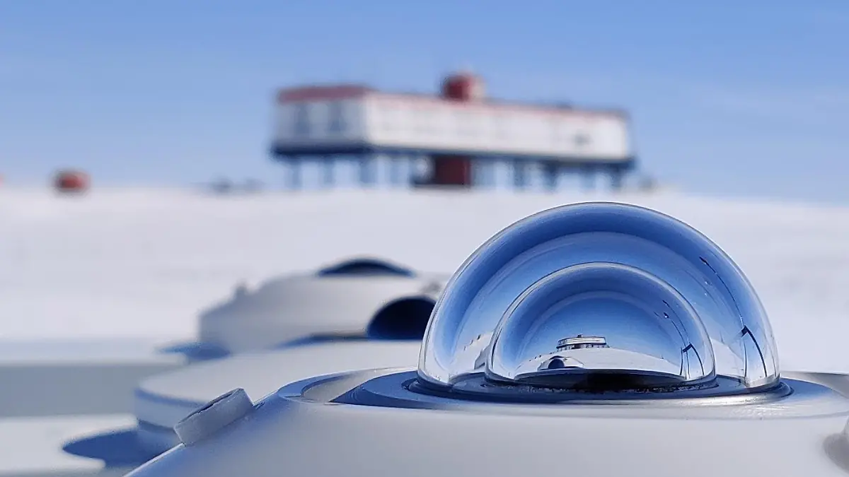 HANDOUT - 13.12.2021, ---, Antarktis: Vor der Neumayer-Station des Alfred-Wegener-Instituts in der Antarktis steht ein Pyranometer - ein Messgerät, das die reflektierten Sonnenstrahlen bestimmt. In der Forschungsstation gibt es an Heiligabend ein Festmahl für das  Wissenschaftlerteam, das dort seit rund einem Jahr lebt. Foto: Peter Jonczyk/Alfred-Wegener-Institut/Helmholtz/dpa - ACHTUNG: Nur zur redaktionellen Verwendung im Zusammenhang mit einer Berichterstattung über Arbeiten des Alfred-Wegener-Instituts zusammen mit dem Copyright-Vermerk +++ dpa-Bildfunk +++