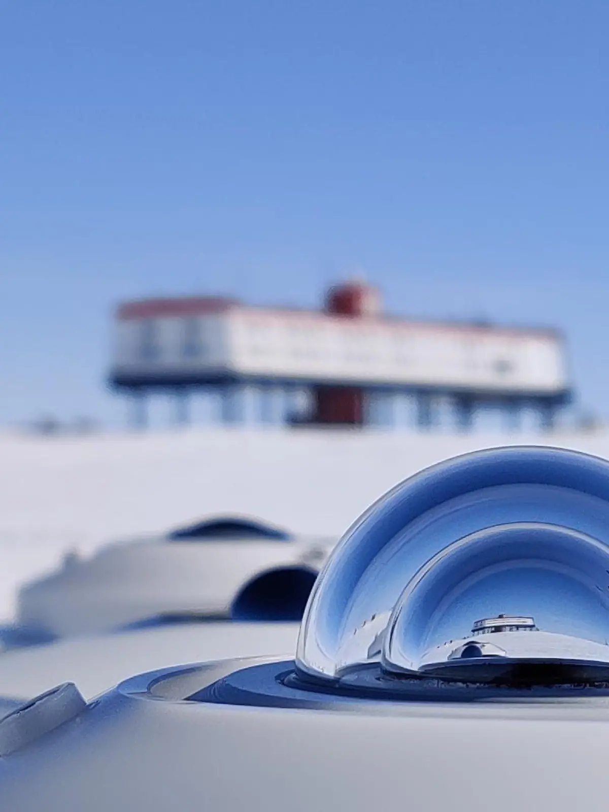 HANDOUT - 13.12.2021, ---, Antarktis: Vor der Neumayer-Station des Alfred-Wegener-Instituts in der Antarktis steht ein Pyranometer - ein Messgerät, das die reflektierten Sonnenstrahlen bestimmt. In der Forschungsstation gibt es an Heiligabend ein Festmahl für das  Wissenschaftlerteam, das dort seit rund einem Jahr lebt. Foto: Peter Jonczyk/Alfred-Wegener-Institut/Helmholtz/dpa - ACHTUNG: Nur zur redaktionellen Verwendung im Zusammenhang mit einer Berichterstattung über Arbeiten des Alfred-Wegener-Instituts zusammen mit dem Copyright-Vermerk +++ dpa-Bildfunk +++