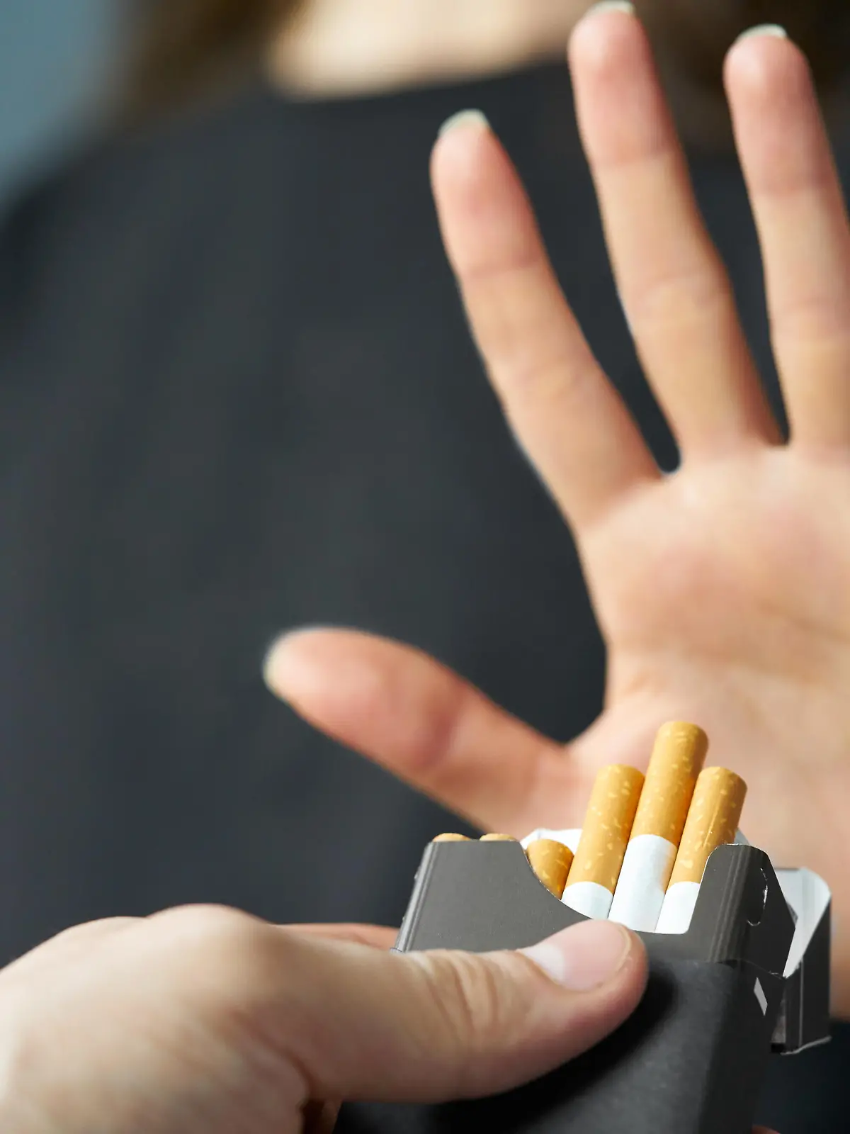                                 Quitting smoking concept. Hand is refusing cigarette offer