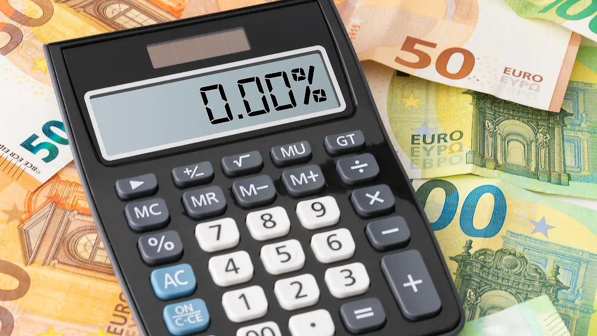 calculator showing zero percent interest rate on Euro banknotes, cheap borrowing concept
