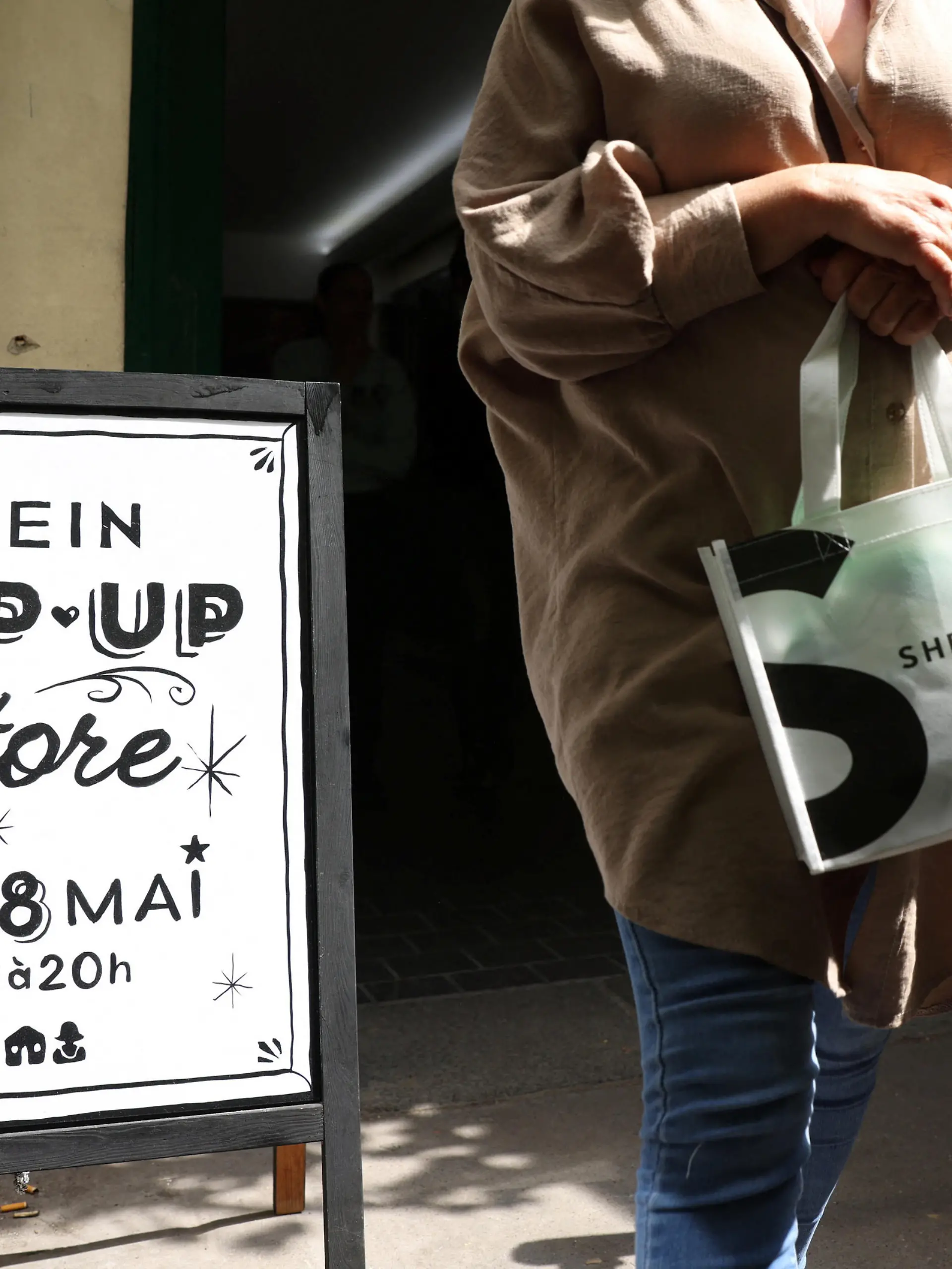 A woman leaves a pop-up store of Chinese fast-fashion retailer Shein in Paris, France, May 5, 2023. REUTERS/Johanna Geron