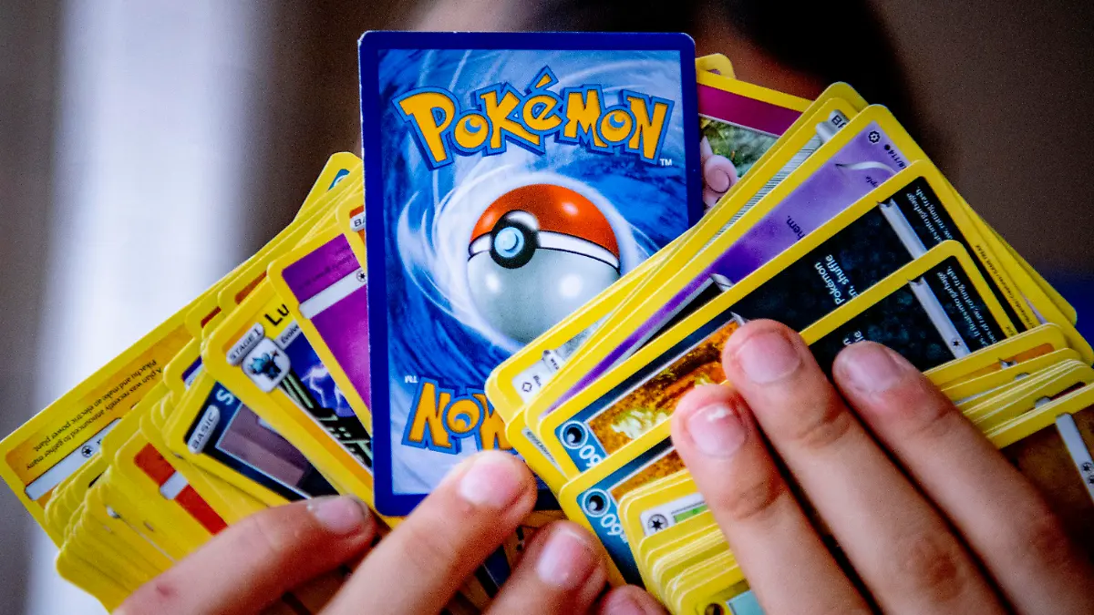 ROTTERDAM - A girl with her pokemon card collection. Pokémon cards are gold and very popular and sold out everywhere. In addition, Pokémon is 25 years old this year and special editions of the cards are now coming out. A pack of 10 cards normally costs around seven euros. Robin Utrecht