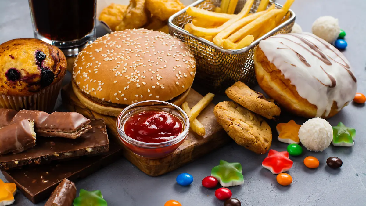 Assortment of unhealthy products that's bad for figure, skin, heart and teeth. Fast carbohydrates food. Space for text