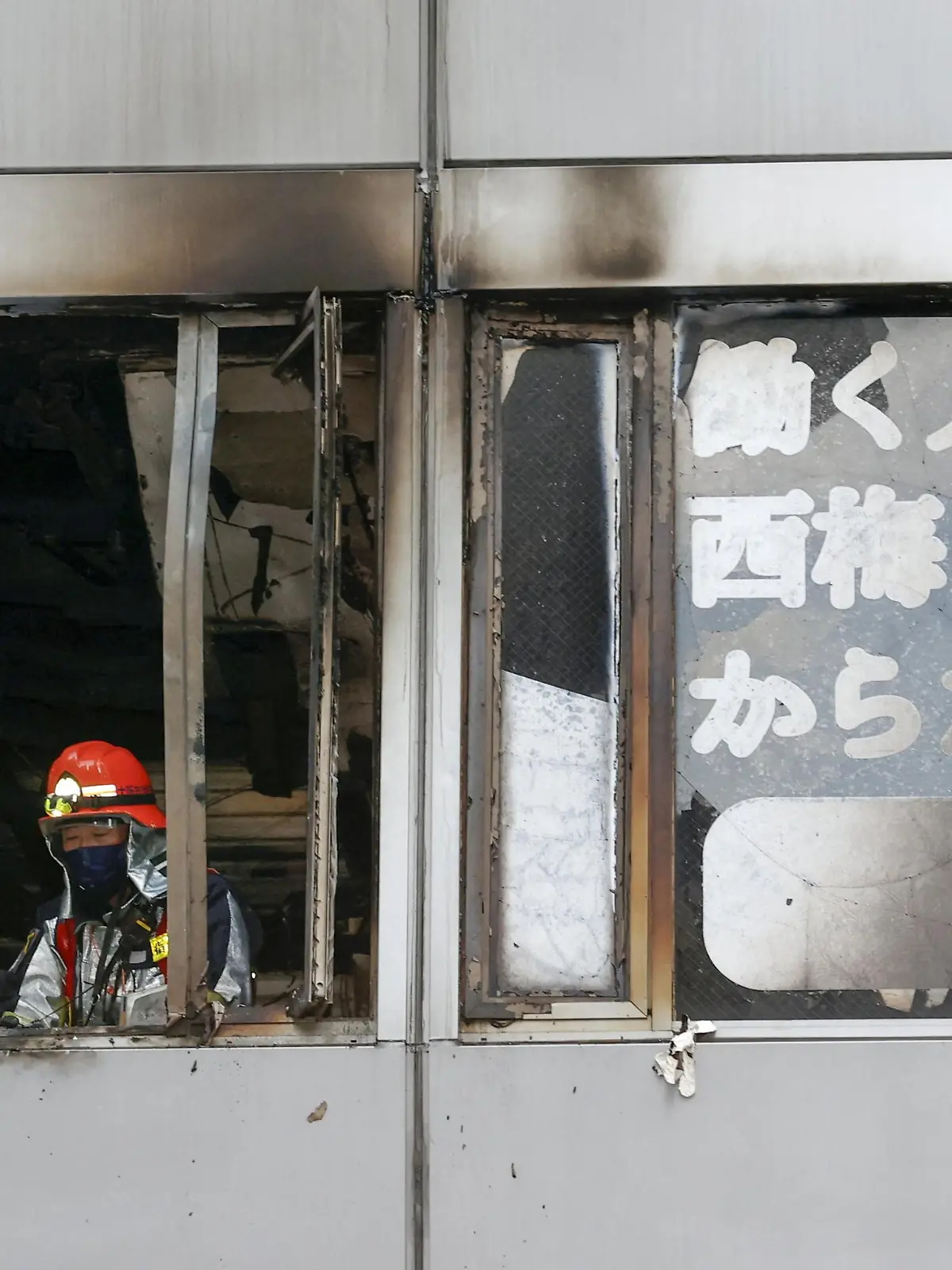 Firefighters are seen at a building where a fire broke out in Osaka, western Japan December 17, 2021 in this photo taken by Kyodo. Kyodo/via REUTERS ATTENTION EDITORS - THIS IMAGE WAS PROVIDED BY A THIRD PARTY. MANDATORY CREDIT. JAPAN OUT. NO COMMERCIAL OR EDITORIAL SALES IN JAPAN