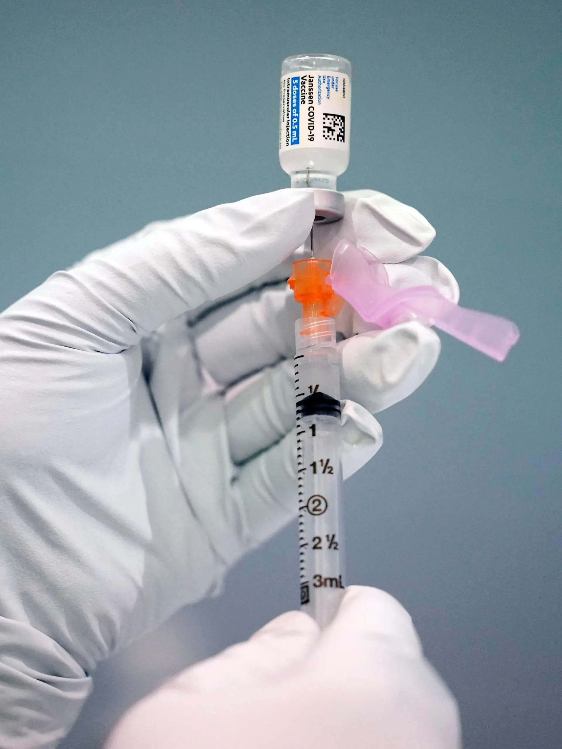 FILE - A member of the Philadelphia Fire Department prepares a dose of the Johnson & Johnson COVID-19 vaccine at a vaccination site setup in Philadelphia, on March 26, 2021.  A government advisory panel is meeting Thursday, Dec. 16,  to determine if any restrictions are needed to the Johnson & Johnson COVID-19 vaccine because of rare but serious blood clots.  (AP Photo/Matt Rourke, File)