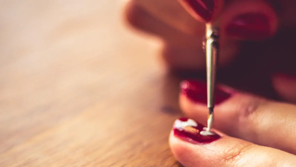 Woman getting manicure.