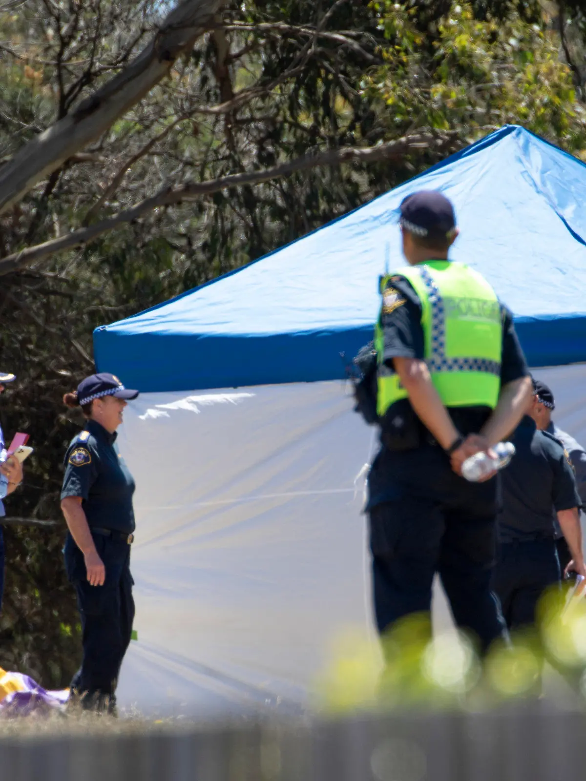 Emergency services personnel work the scene of a deadly incident involved with a jumping castle at the Hillcrest Primary School in Devonport, Tasmania, Thursday, Dec. 16, 2021. Multiple children have died and others are in critical condition after falling from a bouncy castle that was lifted 10 meters (33 feet) into the air by a gust of wind at a junior school on the island state of Tasmania on Thursday. (Grant Wells/AAP Image via AP)