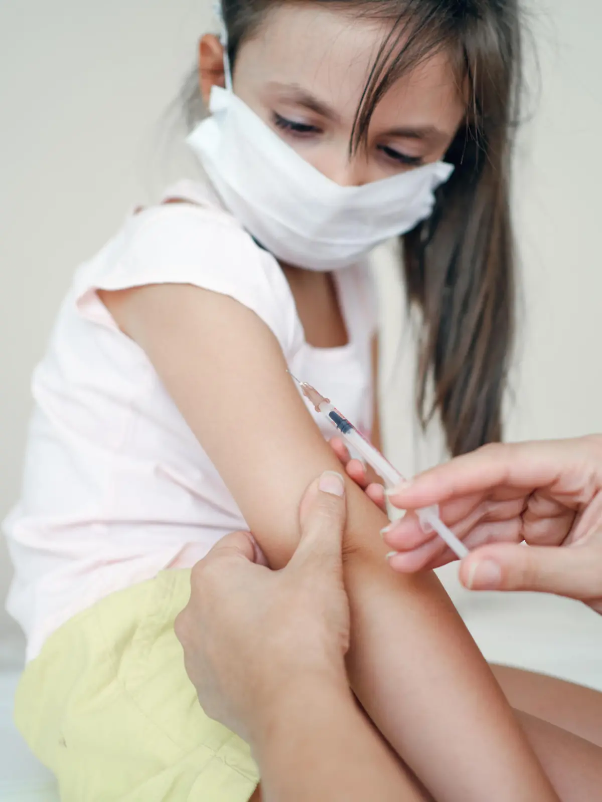 Pediatrician makes vaccination to cute girl