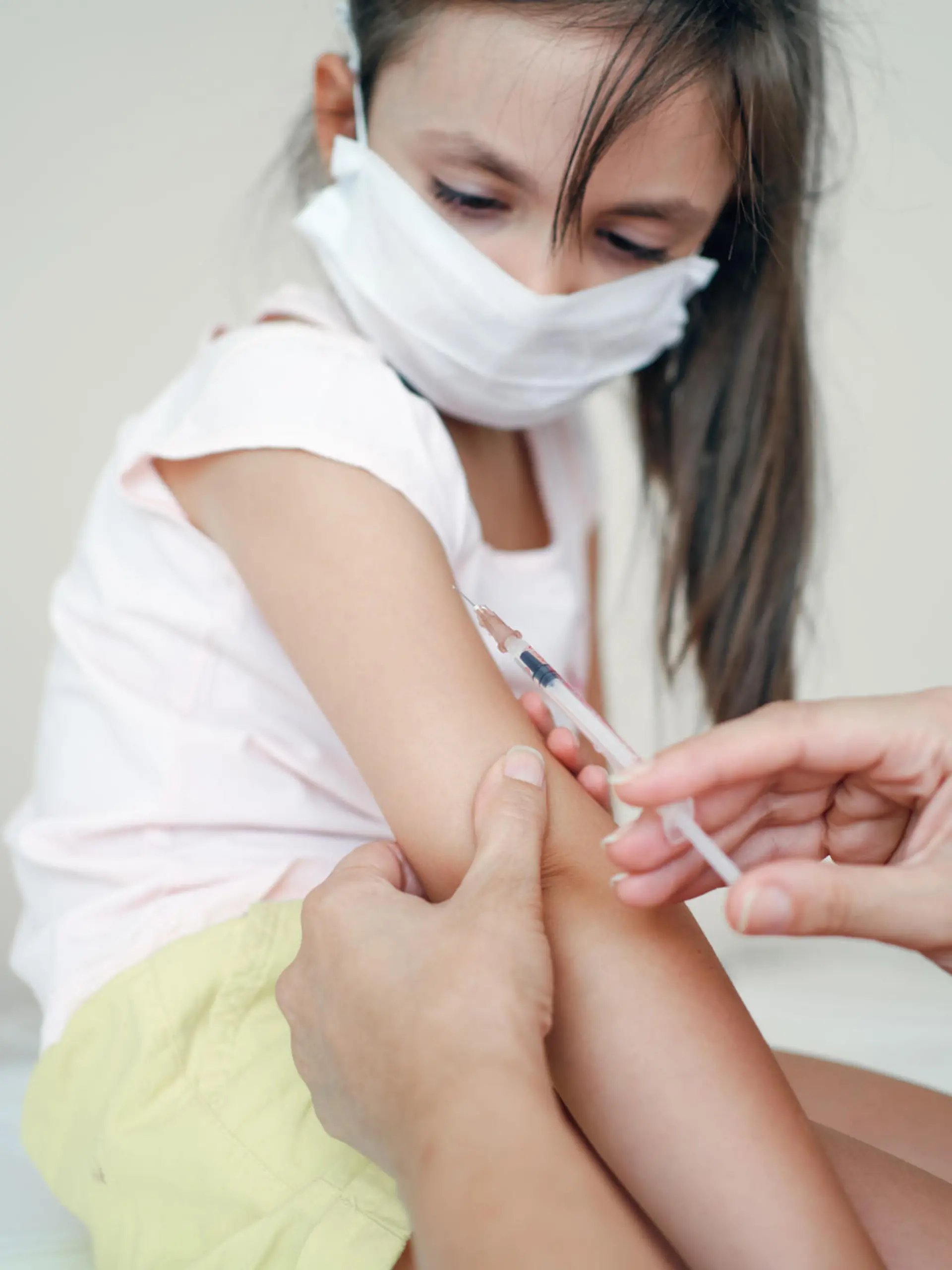 Pediatrician makes vaccination to cute girl
