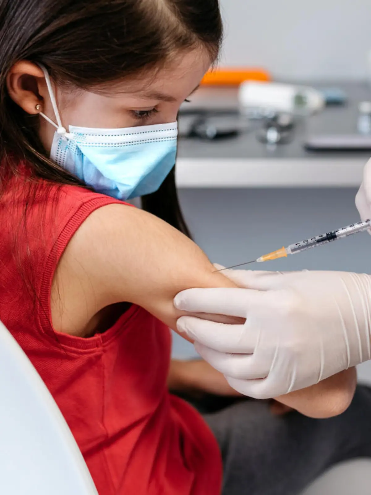 Little girl receiving coronavirus vaccine at doctor's office