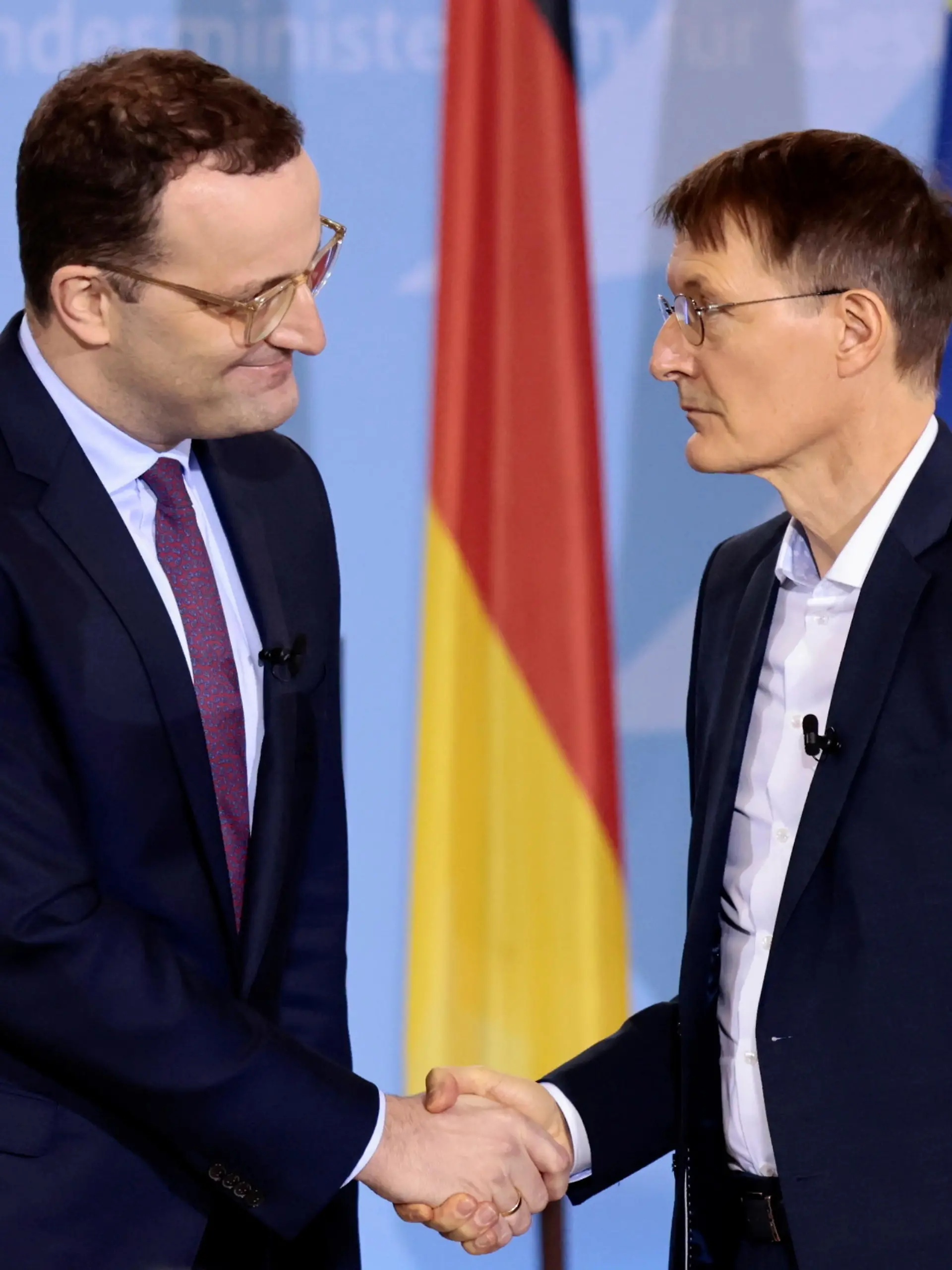 Germany's former Health Minister Jens Spahn shakes hands with the new Health Minister Karl Lauterbach during the handover ceremony in Berlin, Germany, December 8, 2021. REUTERS/Hannibal Hanschke/Pool