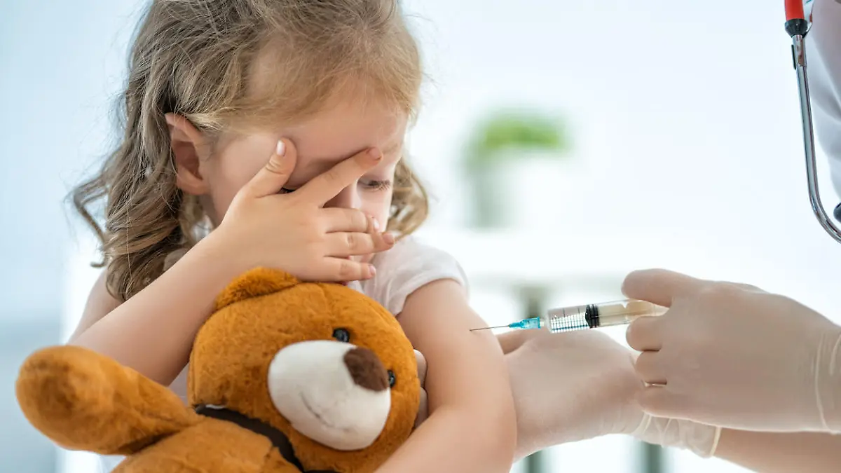 A doctor making a vaccination to a child