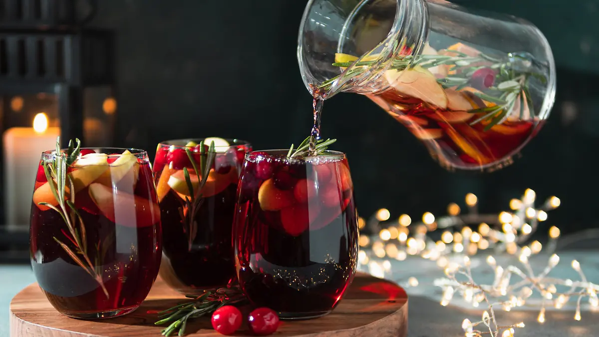 Winter sangria pouring in glasses, christmas table