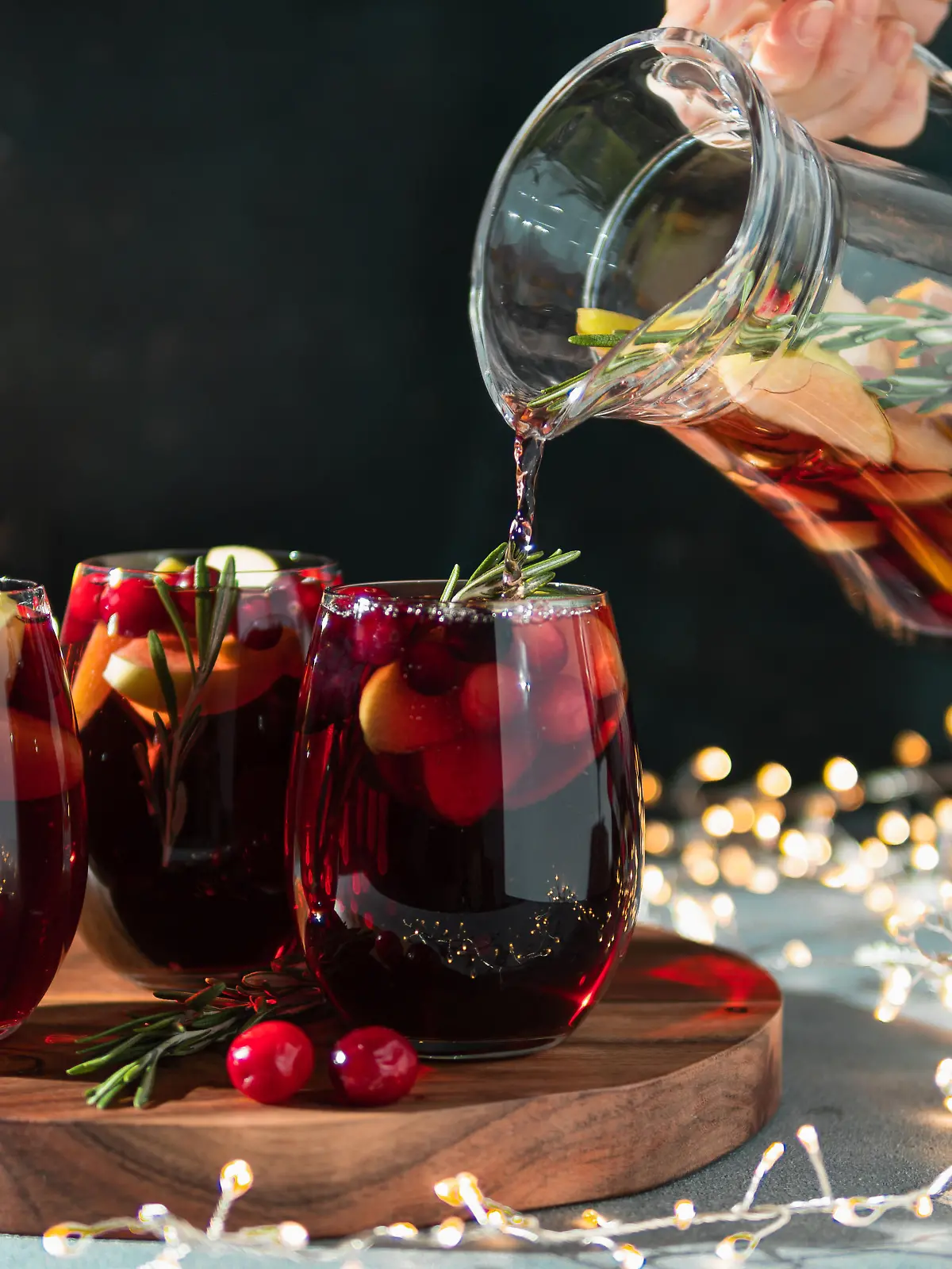 Winter sangria pouring in glasses, christmas table