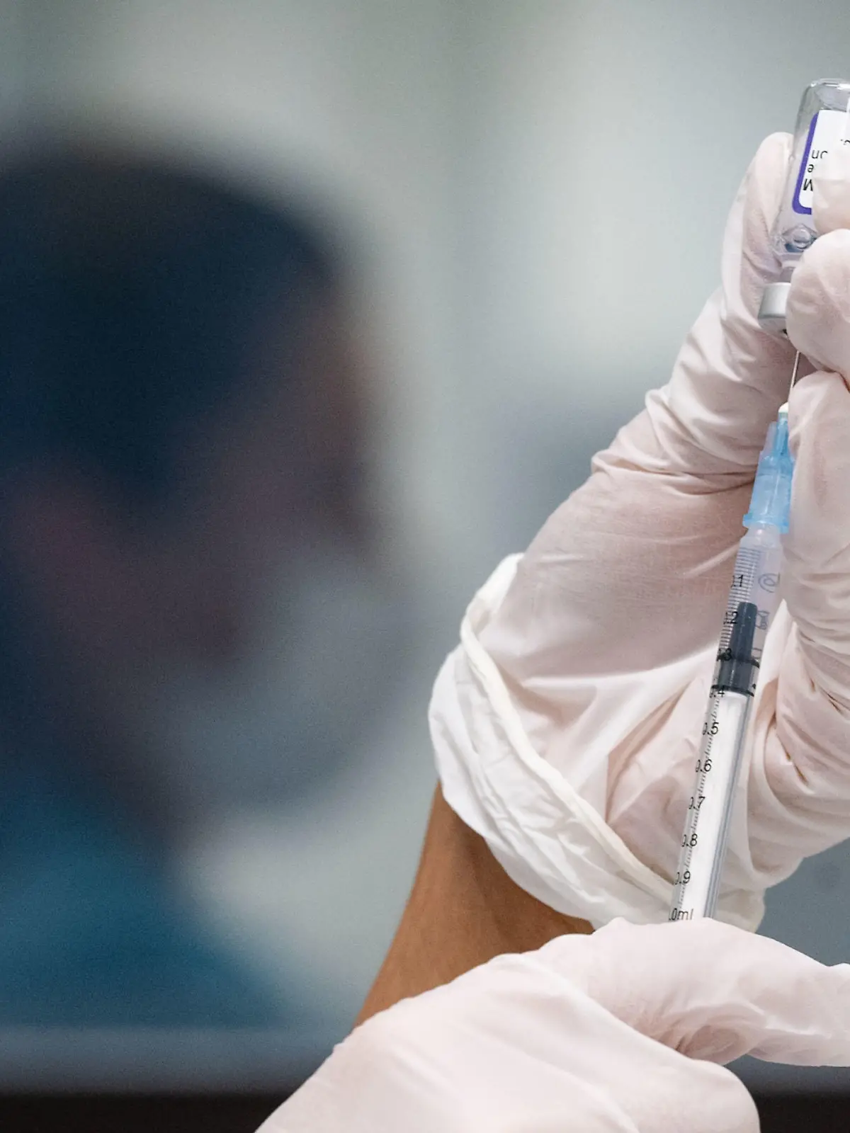 ARCHIV - 25.11.2021, Baden-Württemberg, Gerlingen: Eine Werksärztliche Assistentin zieht in einem betrieblichen Impfzentrum eine Dosis des Impfstoffes von Biontech/Pfizer auf. Mehrere Forscherteams haben in ersten Labortests festgestellt, dass Antikörper von Geimpften vergleichsweise schlecht auf die neue Omikron-Variante des Coronavirus ansprechen. (zu dpa «Hinweise aus dem Labor: Impfungen wohl weniger effektiv gegen Omikron») Foto: Marijan Murat/dpa +++ dpa-Bildfunk +++