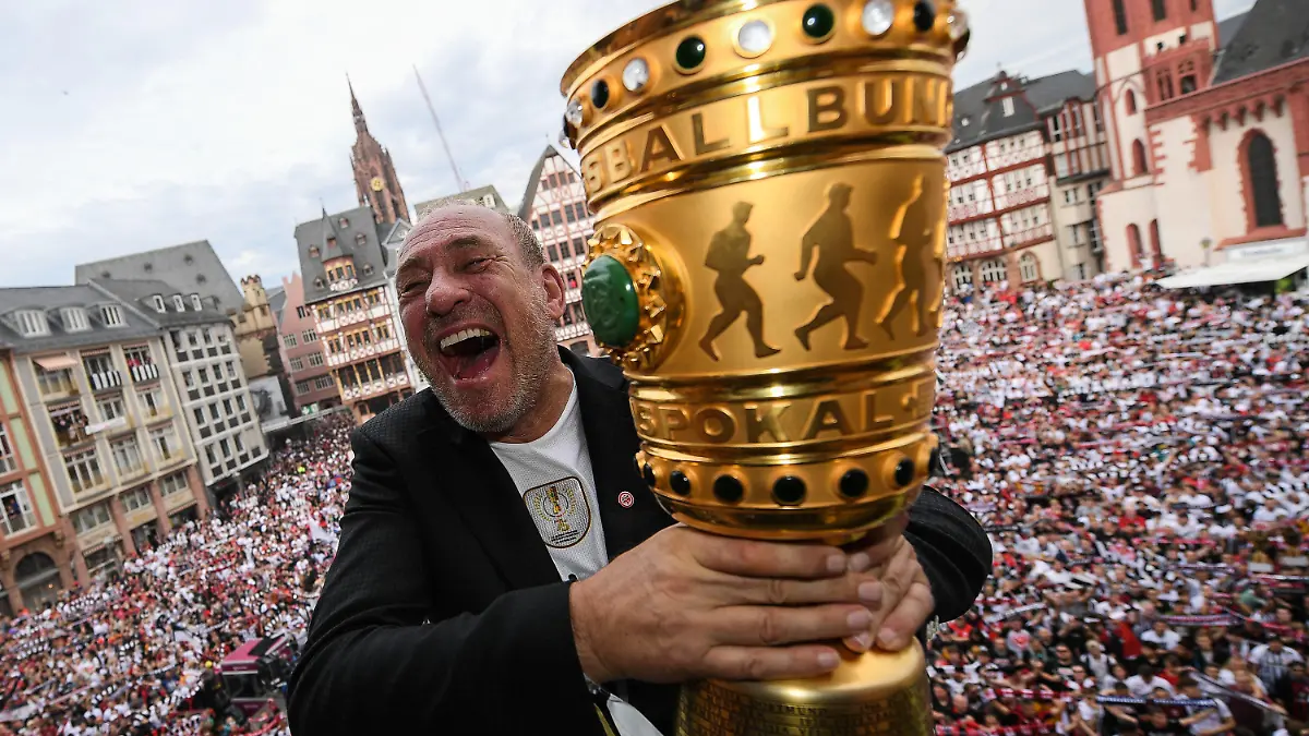 ARCHIV - 20.05.2018, Hessen, Frankfurt/Main: 20.05.2018, Hessen, Frankfurt am Main: Peter Fischer, Präsident von Eintracht Frankfurt, hält auf dem Balkon des Römer den DFB Pokal in den Händen. Der Römerberg mit den vielen Fans ist durch Pyrotechnik verraucht. Eintracht Frankfurt hat das Finale des DFB-Pokals mit 3:1 gegen den FC Bayern München gewonnen. Nun stehen die Hessen gegen Leipzig erneut im Endspiel. (zu dpa: «Prämie, Schiri, Brause: Fragen und Antworten zum Pokalfinale») Foto: Andreas Arnold/dpa +++ dpa-Bildfunk +++