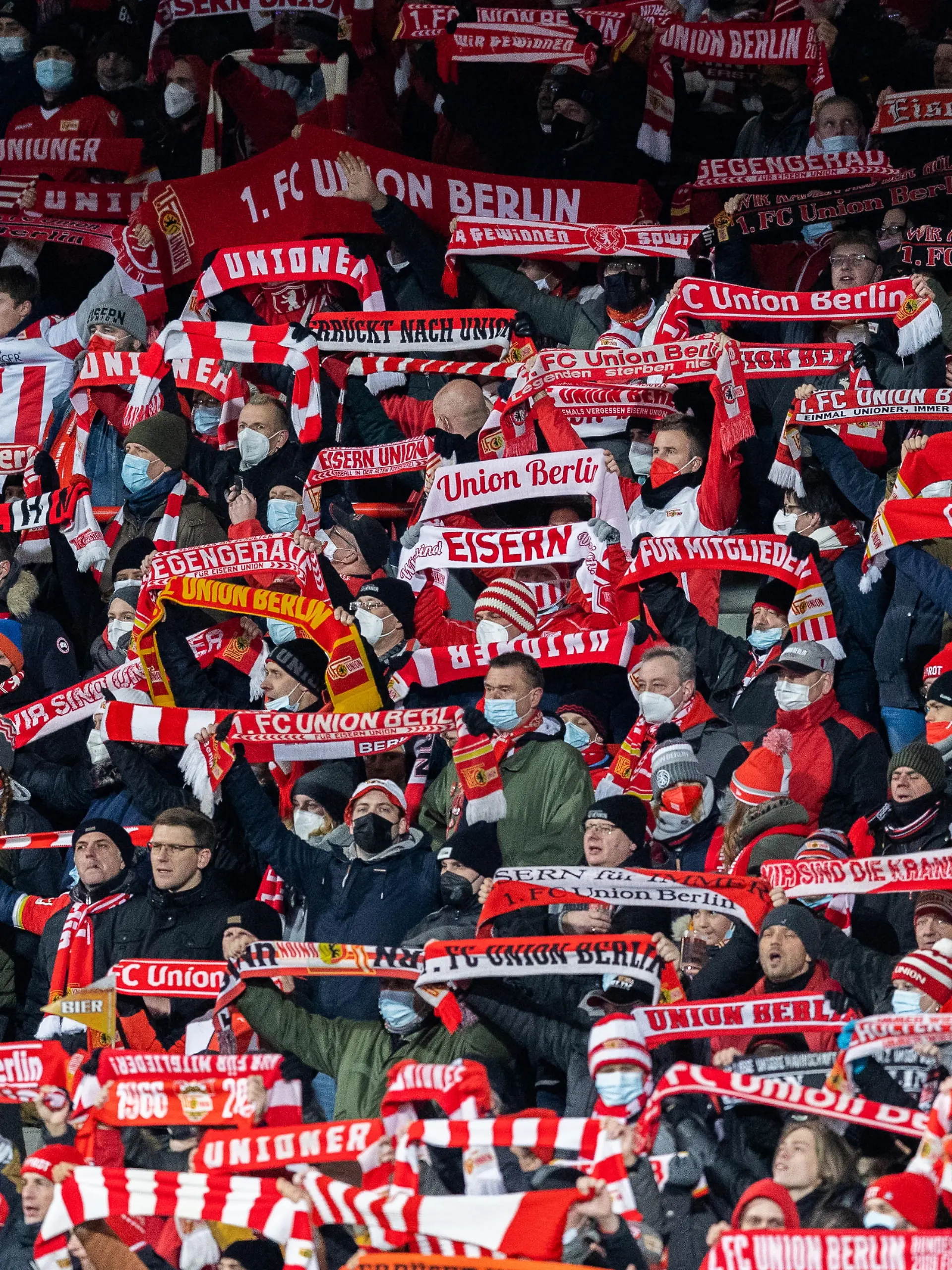BERLIN, GERMANY - DECEMBER 03: Fans of Union Berlin celebrate during the Bundesliga match between 1. FC Union Berlin and RB Leipzig at Stadion An der Alten Foersterei on December 03, 2021 in Berlin, Germany. (Photo by Boris Streubel/Getty Images)