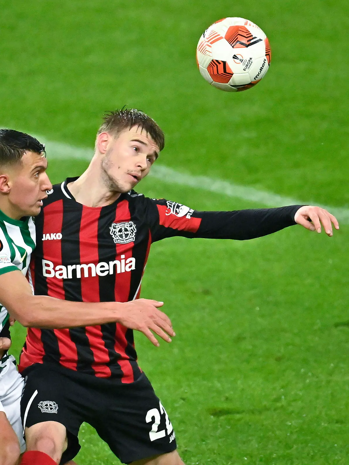 Ferencvaros' Myrto Uzuni, left, and Bayer Leverkusen's Daley Sinkgraven fight for the ball during the Europa League group G 6th soccer match Ferencvaros and Bayer Leverkusen in Groupama Arena in Budapest, Hungary, Thursday, Dec. 9, 2021. (Szilard Koszticsak/MTI via AP)