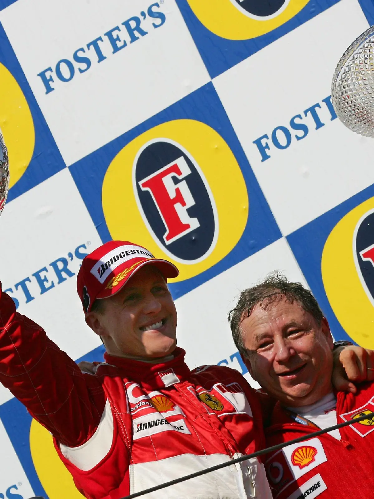 German Formula One driver Michael Schumacher (Ferrari) and his teamchief French Jean Todt (R) jubilate on the podium after the Grand Prix of San Marino at the F1 race track in Imola, Italy, Sunday 23 April 2006. Photo: Gero Breloer +++(c) dpa - Bildfunk+++