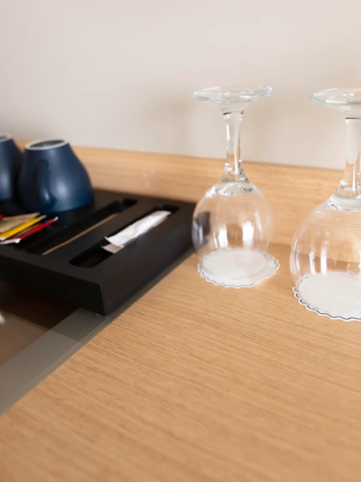 Cup of coffee placing on a wooden small table in hotel room