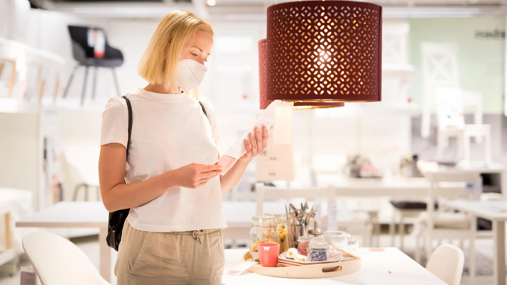 New normal during covid epidemic. Caucasian woman shopping at retail furniture and home accessories store wearing protective medical face mask to prevent spreading of corona virus. || Modellfreigabe vorhanden