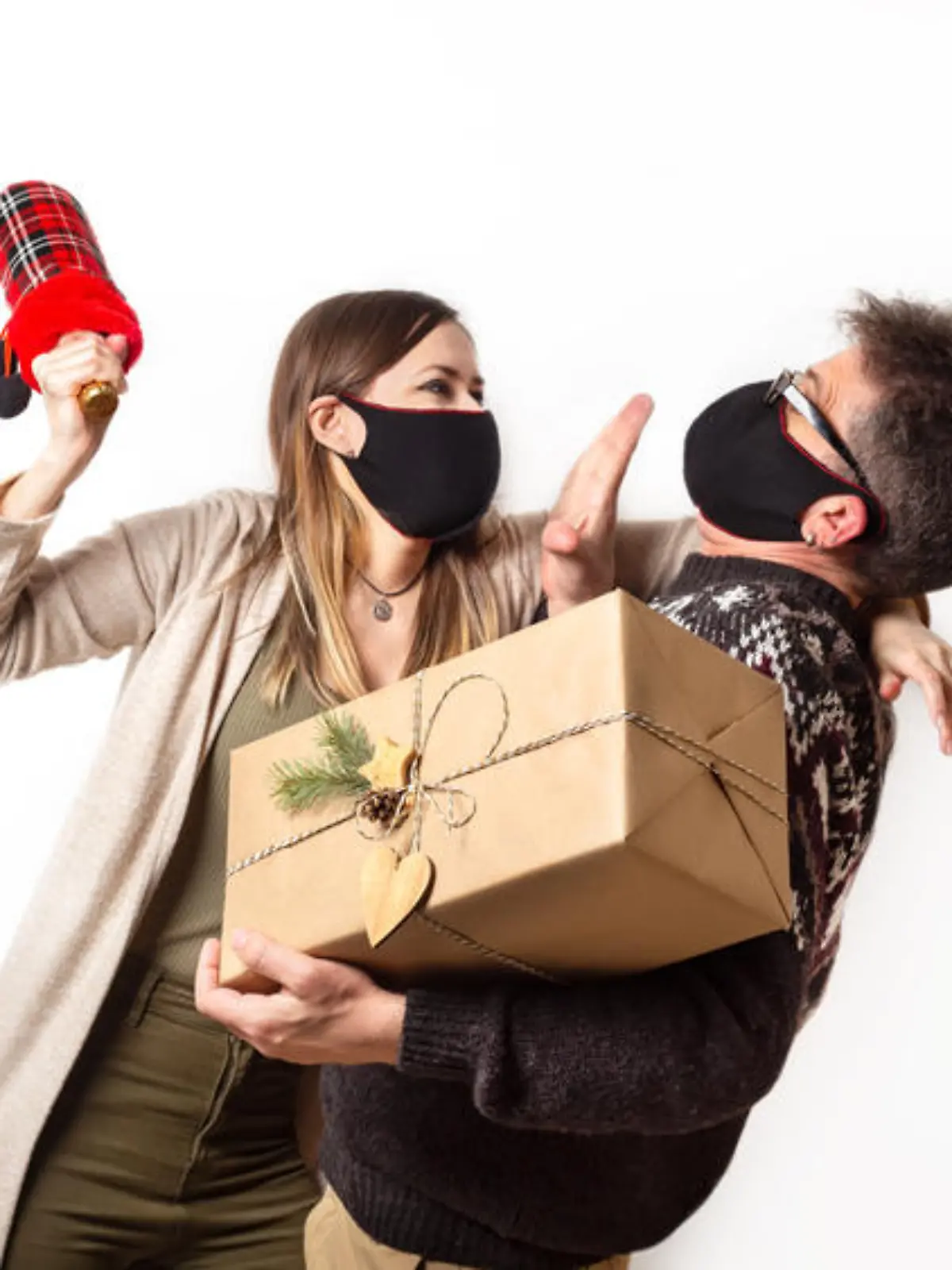 Abusing couple in black protective covid masks with gift and bottle of champagne. Domestic violence between husband and his wife during quarantine. Disappointment of Christmas gift. Family quarrel