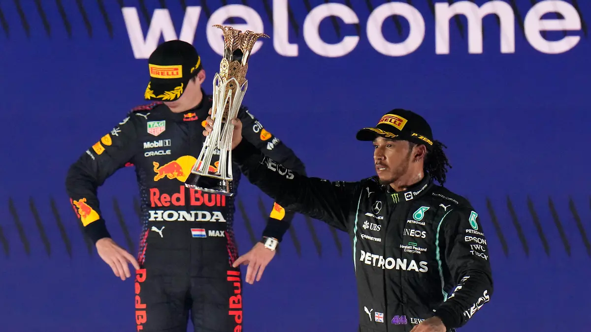 Mercedes driver Lewis Hamilton of Britain celebrates winning the Formula One Saudi Arabian Grand Prix in front of the second placed Red Bull driver Max Verstappen of the Netherlands, in Jiddah, Sunday, Dec. 5, 2021. (AP Photo/Hassan Ammar)